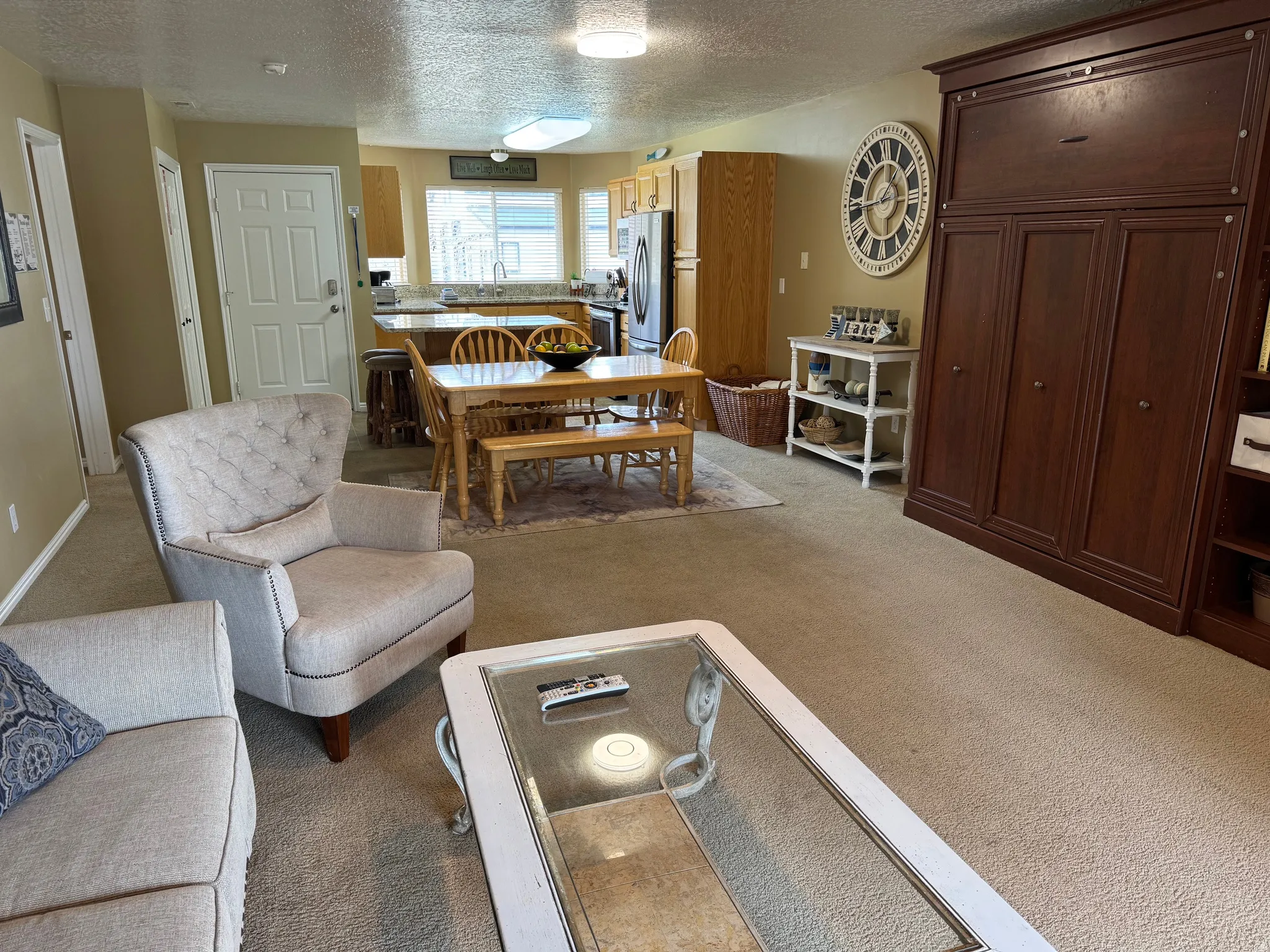 Living area featuring a textured ceiling and light carpet