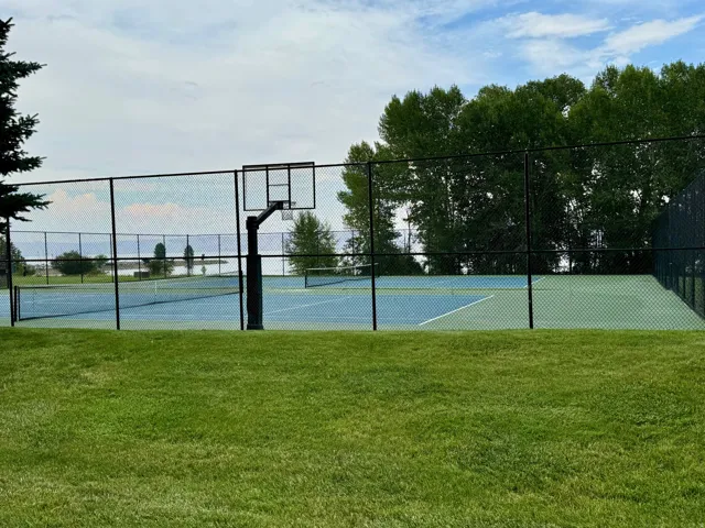 View of tennis court with community basketball court