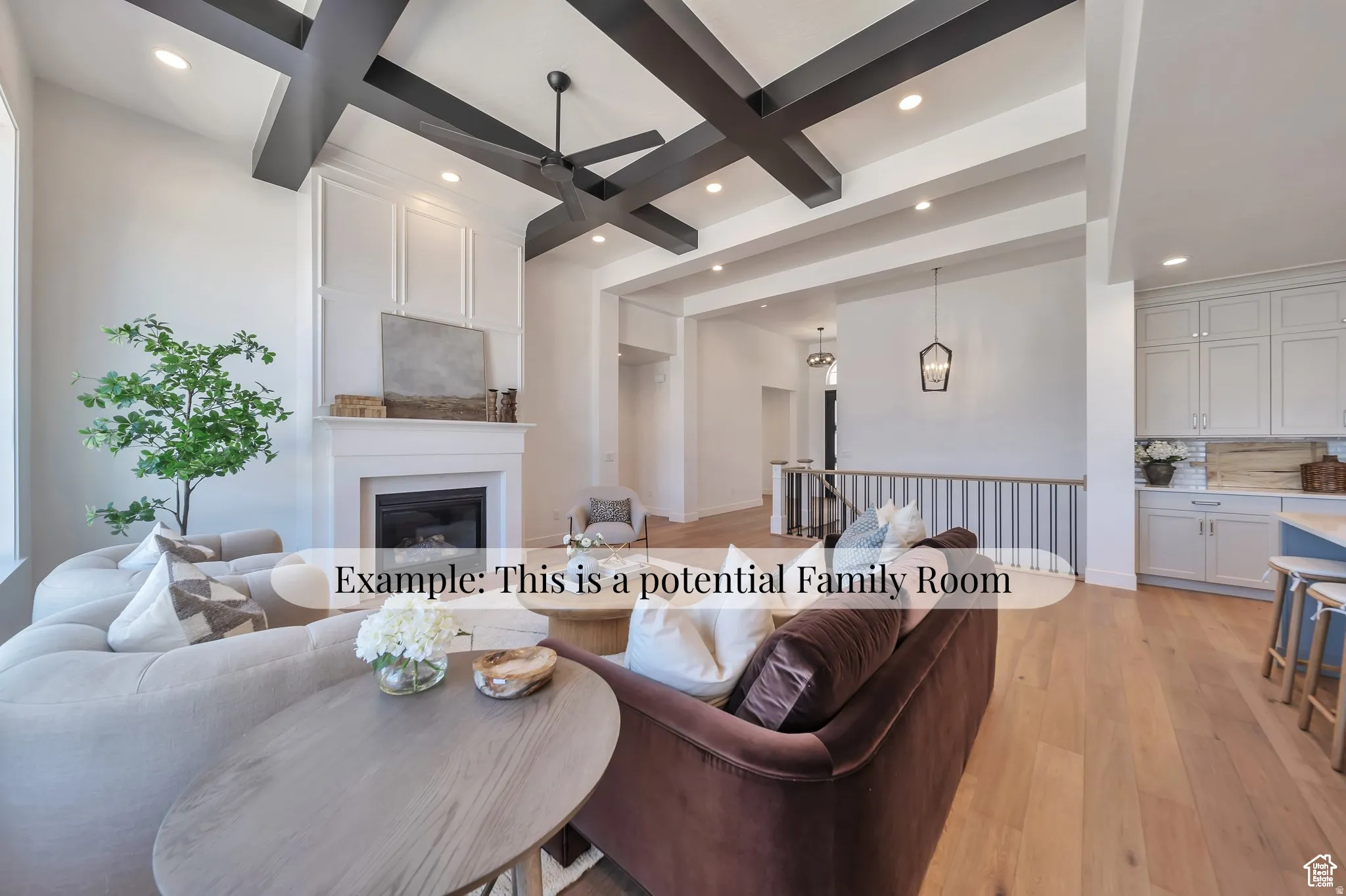 Living area featuring coffered ceiling, light wood finished floors, a ceiling fan, a large fireplace, and recessed lighting