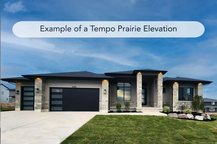 Prairie-style house with stone siding, a garage, a front yard, and driveway