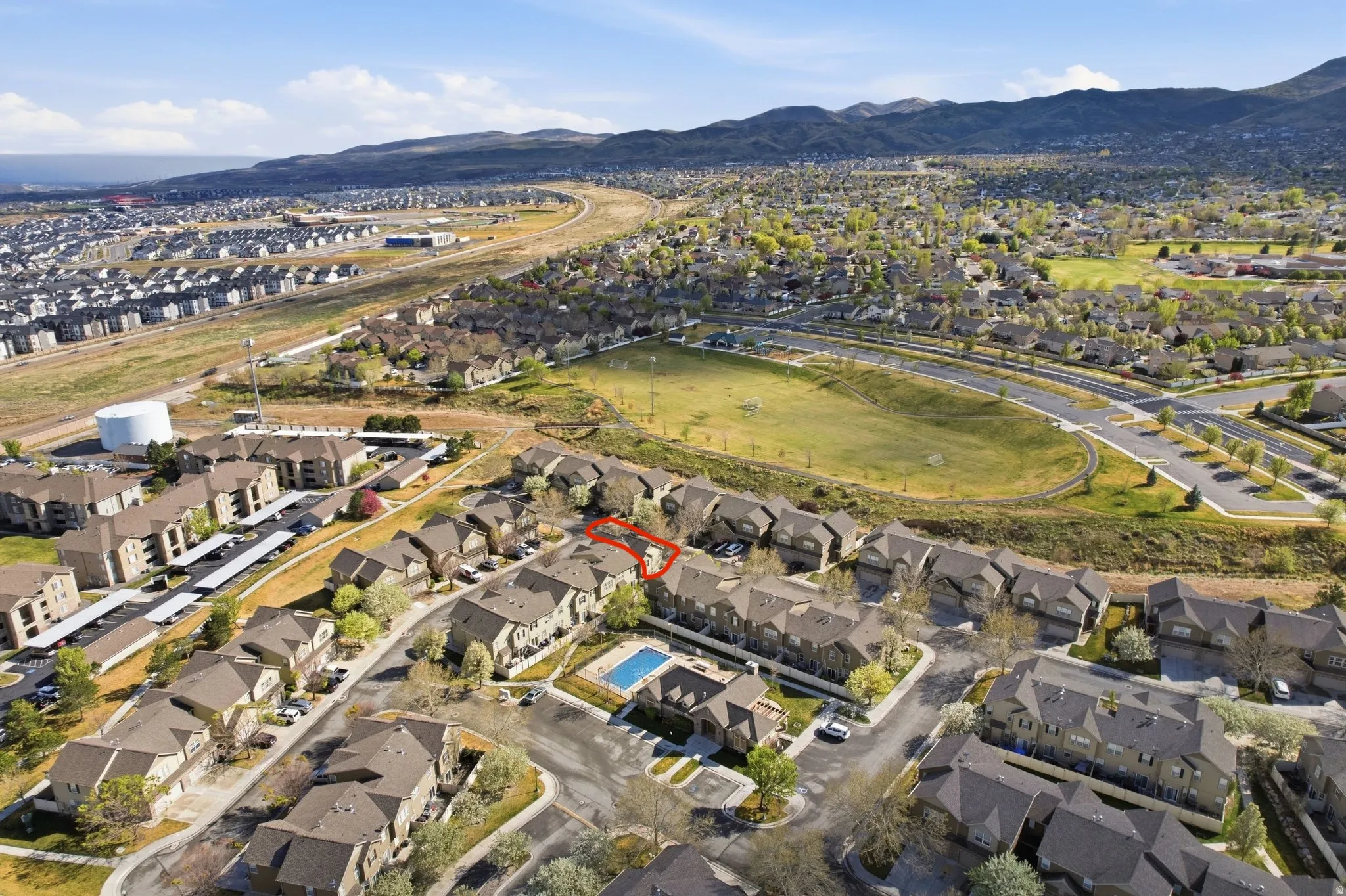 Aerial overview of property's location featuring nearby suburban area and a mountain backdrop