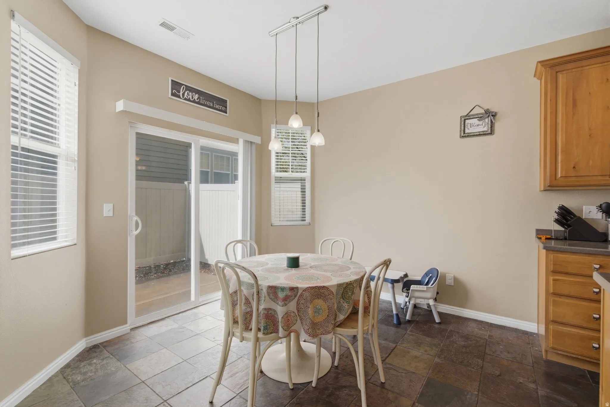 Dining space featuring dark stone finish floors and track lighting