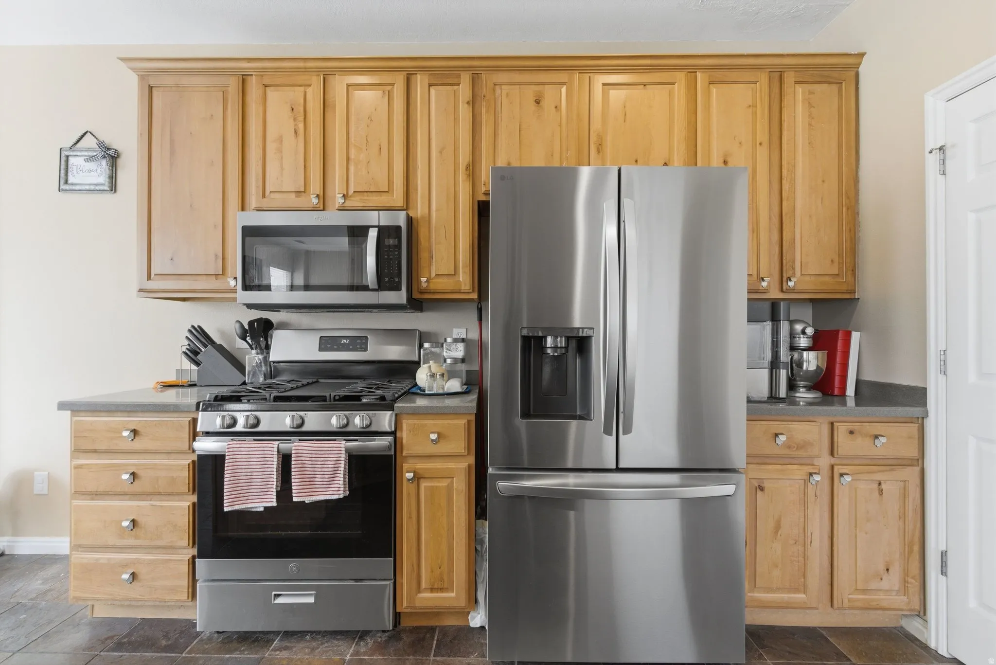 Kitchen with stainless steel appliances and dark countertops