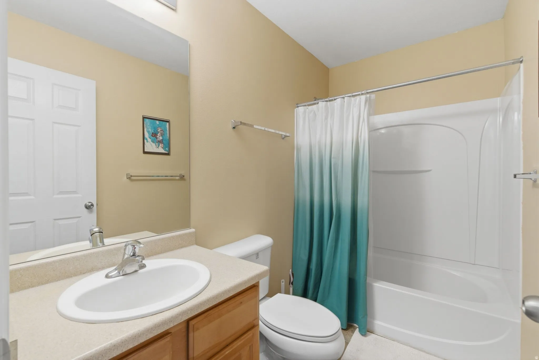 Full bathroom featuring vanity and shower / bath combination with curtain