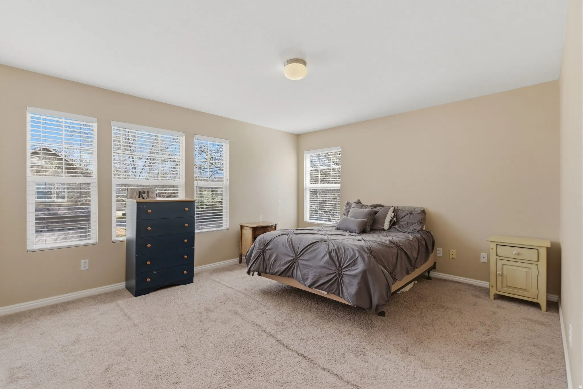 Bedroom featuring light carpet