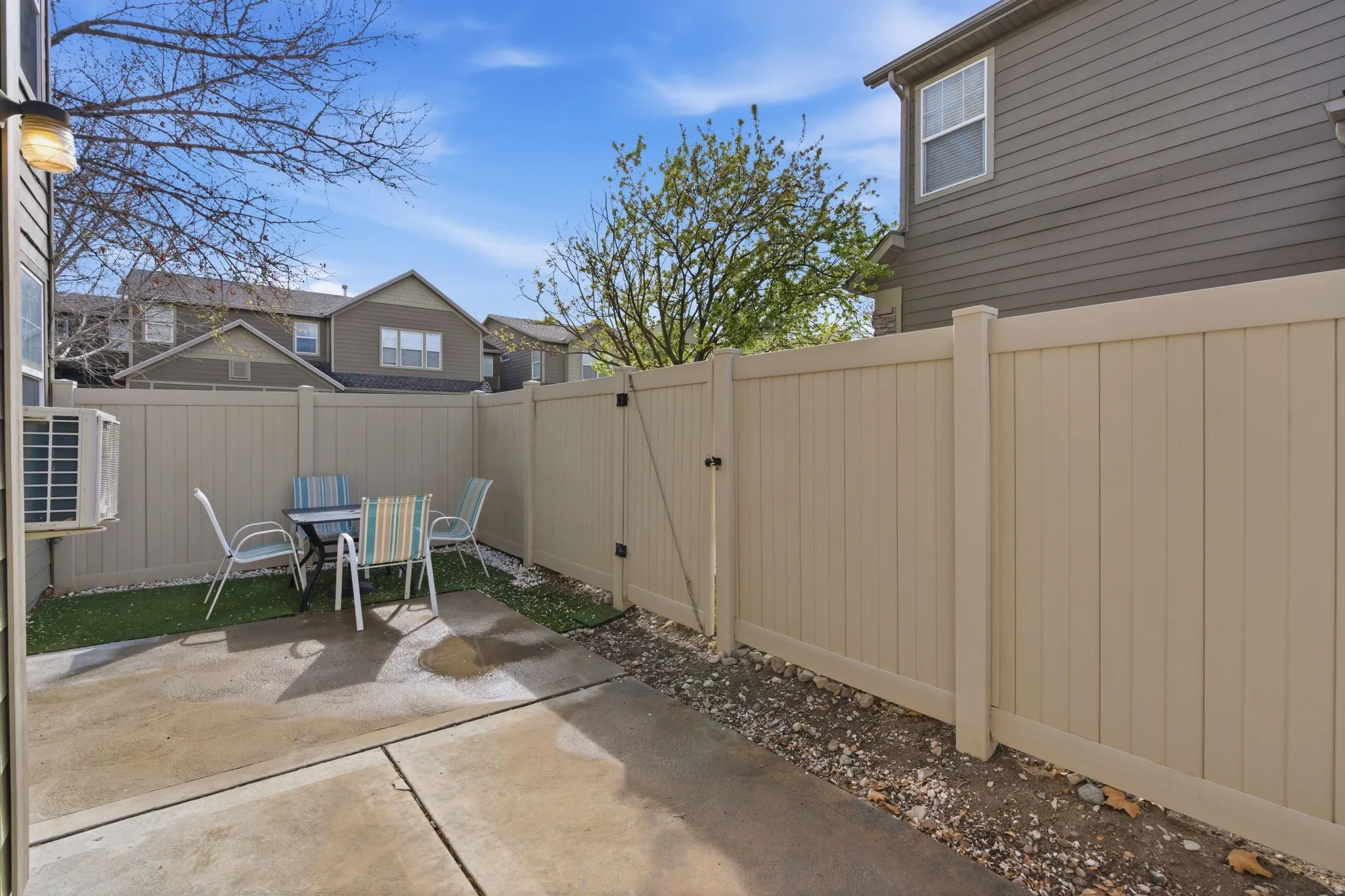 Fenced backyard with a patio area and a gate