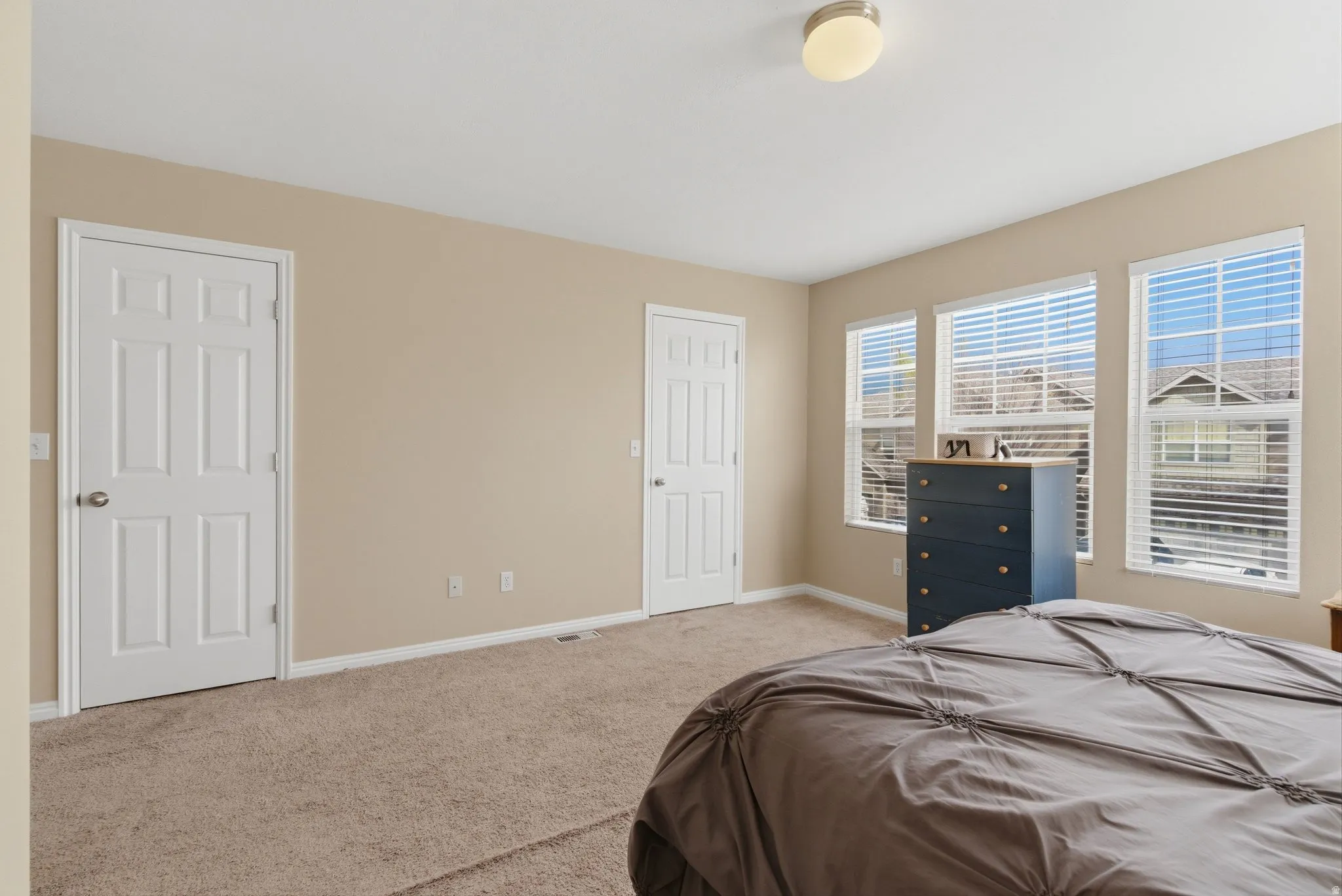 Bedroom featuring carpet flooring and baseboards