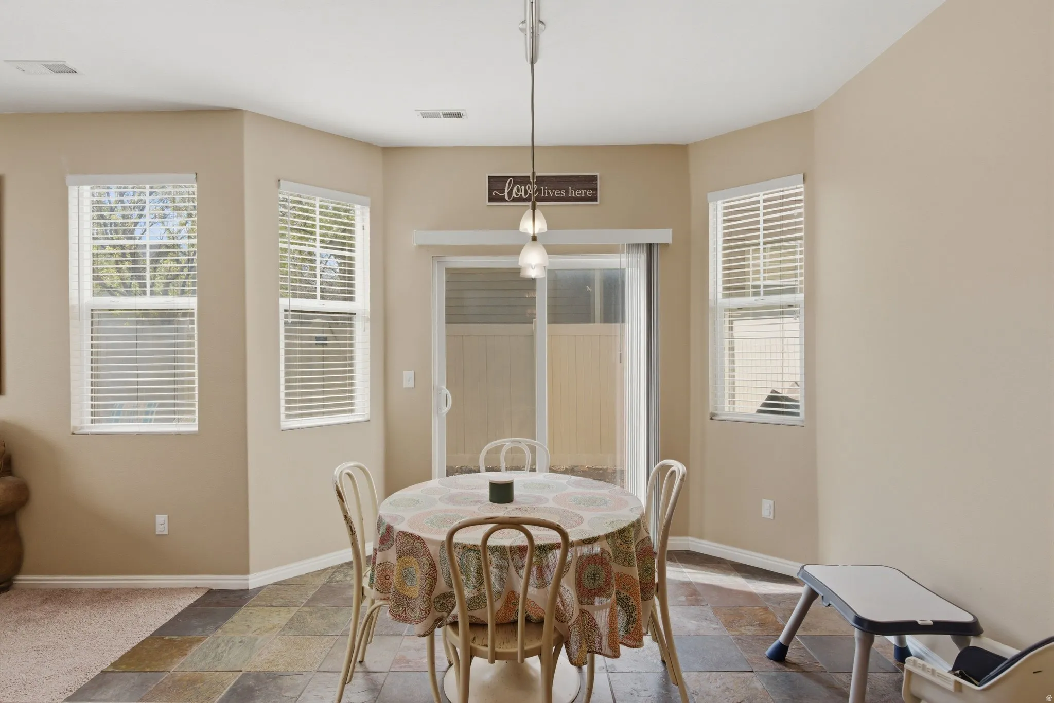 Dining space with stone tile flooring