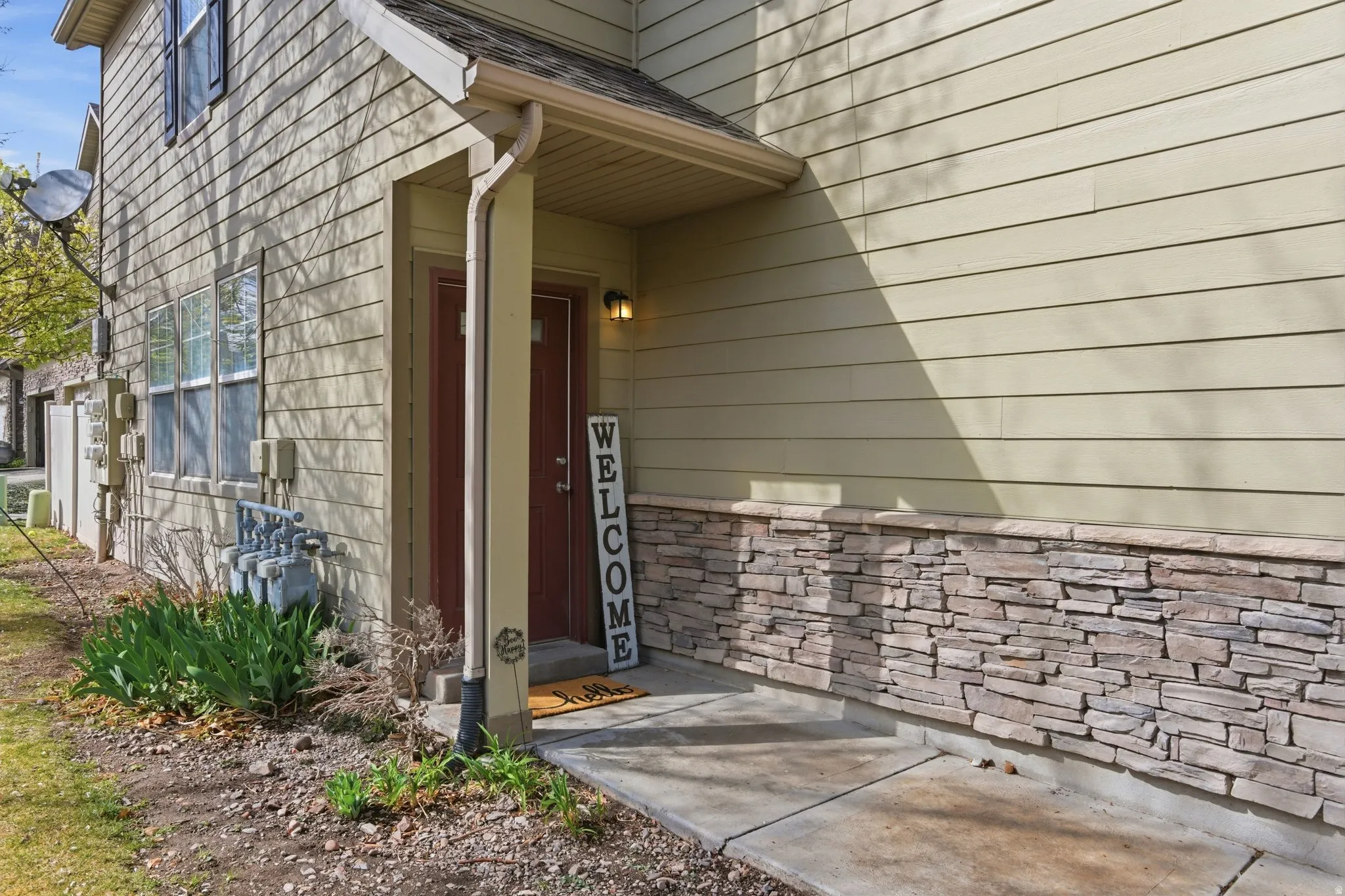 Doorway to property featuring roof with shingles