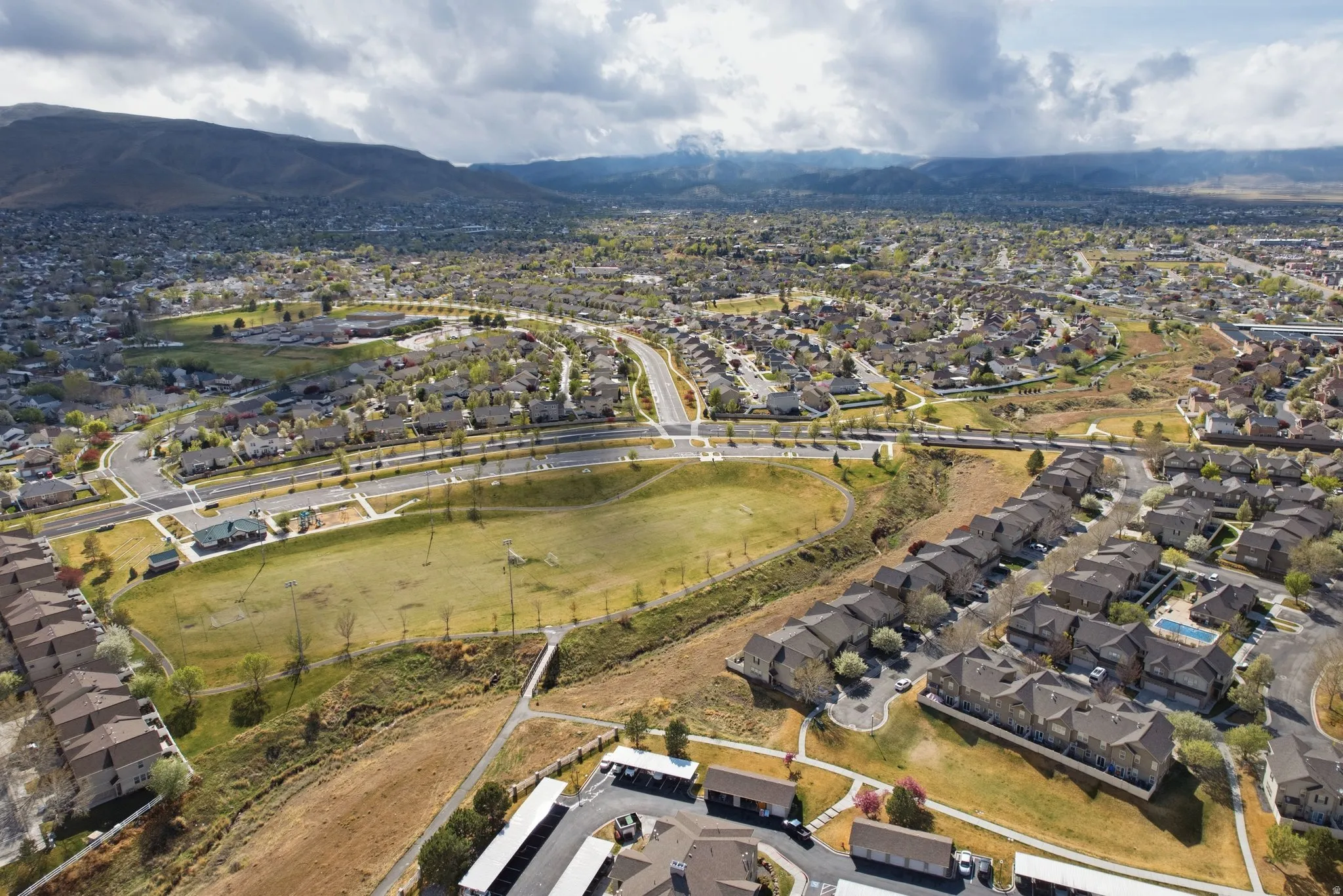 View of property location featuring mountains and nearby suburban area