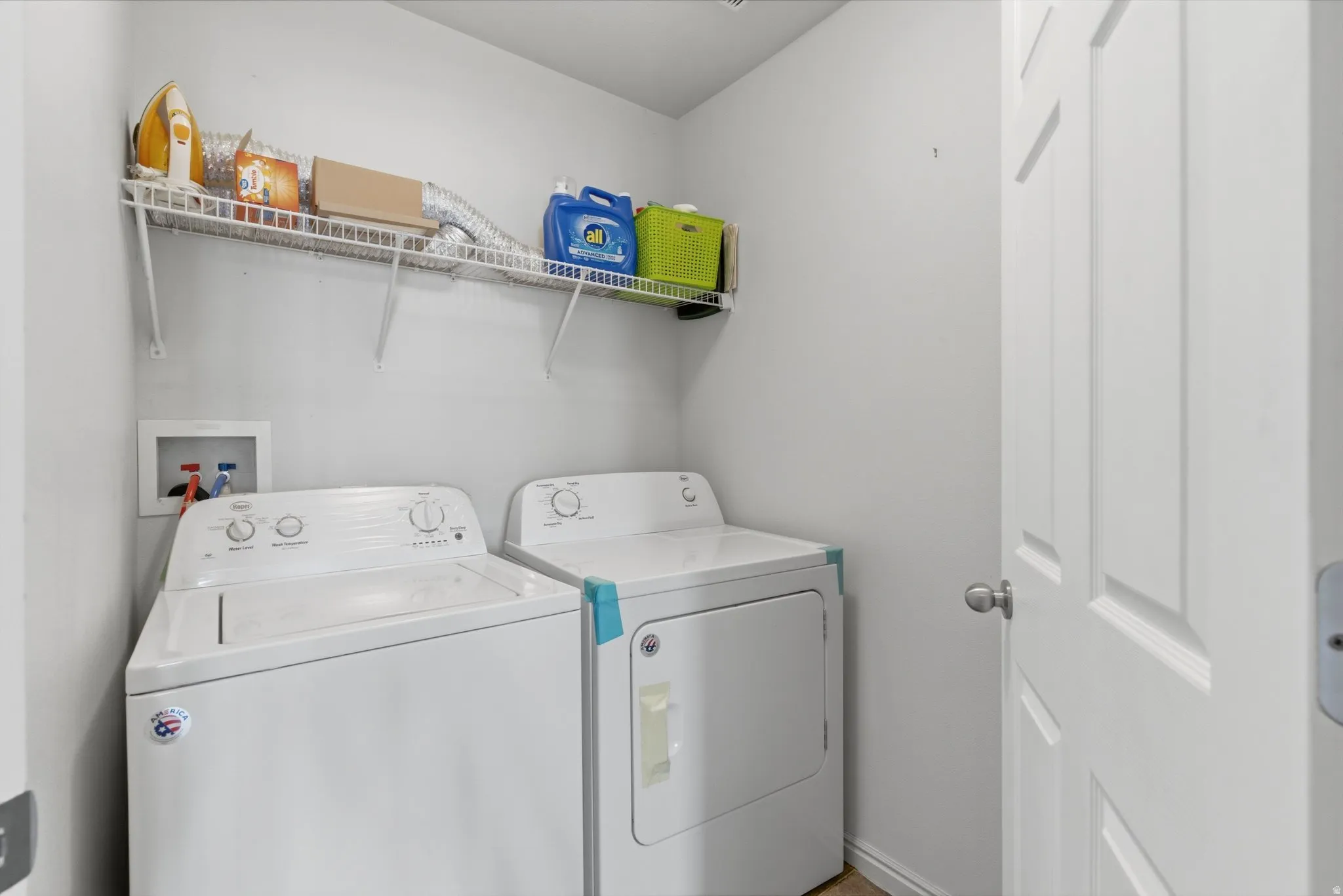 Laundry room featuring separate washer and dryer and baseboards