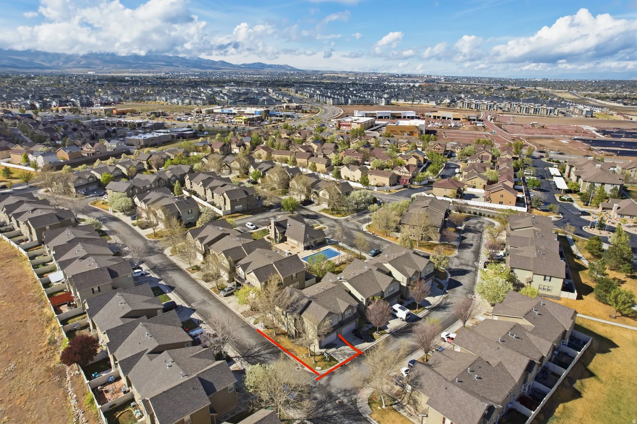 Aerial perspective of suburban area featuring a mountain backdrop