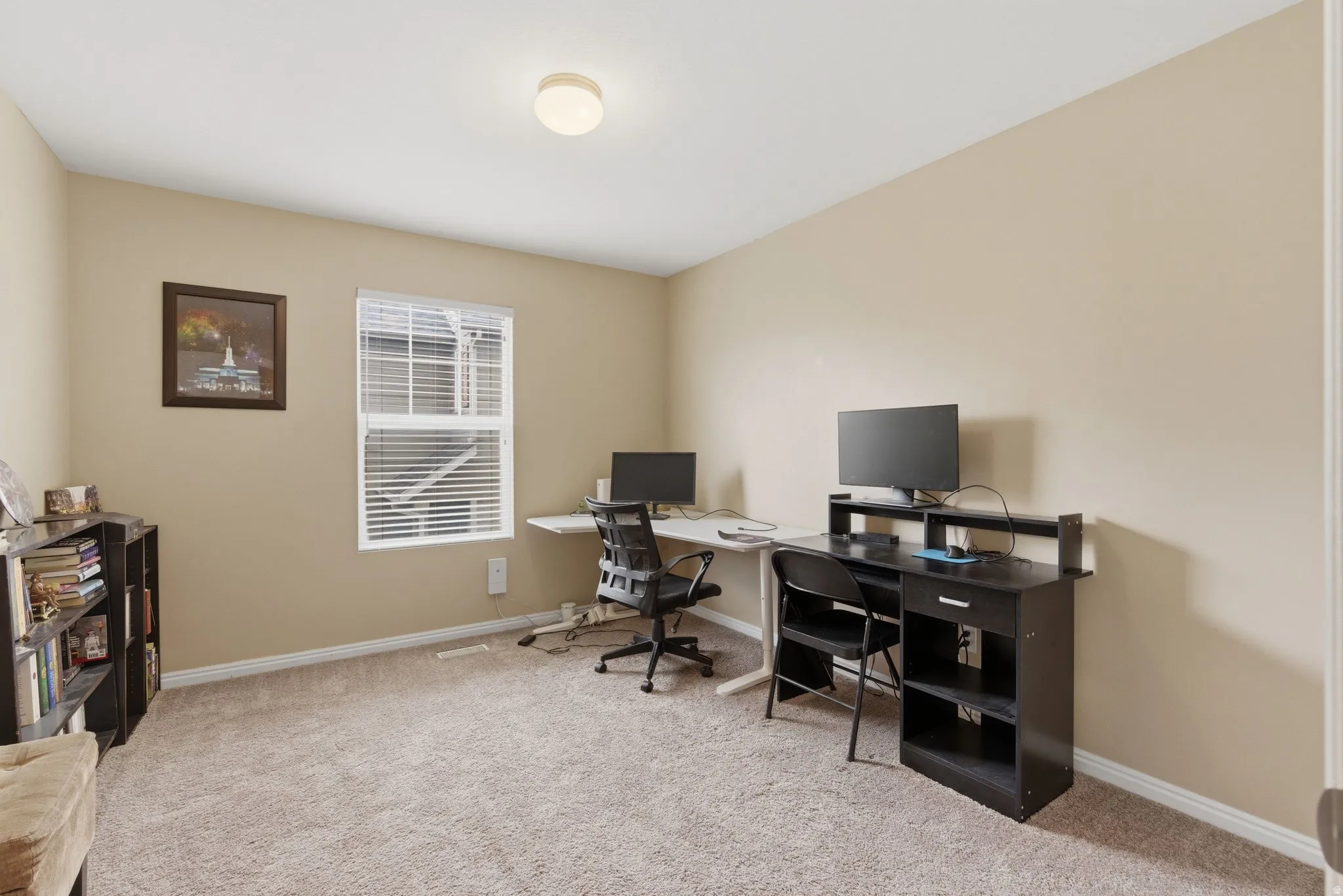 Office space featuring light colored carpet