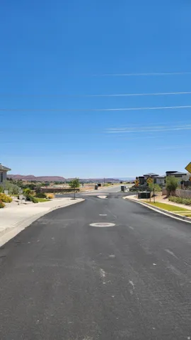View of asphalt road featuring sidewalks, curbs, and a residential view