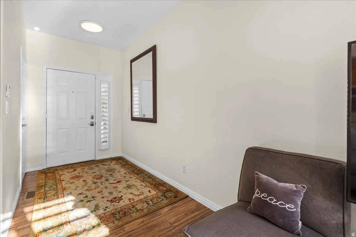 Foyer with wood finished floors and baseboards
