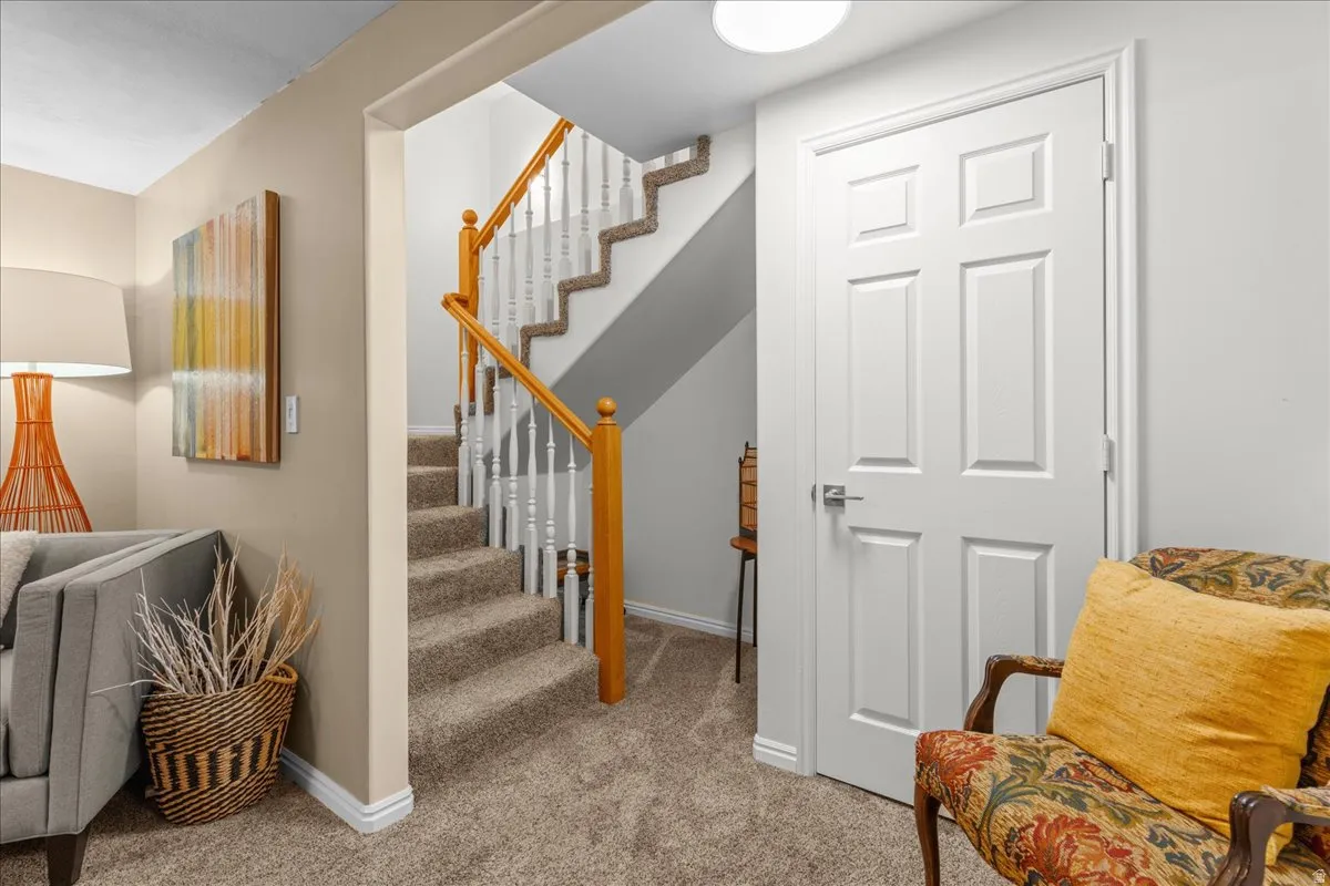 Staircase with carpet flooring and baseboards