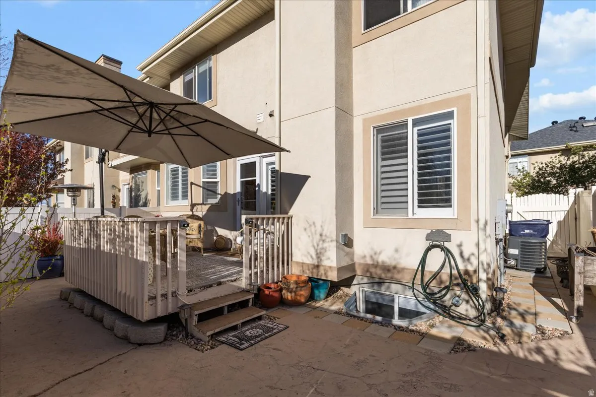 Back of house featuring stucco siding and a wooden deck