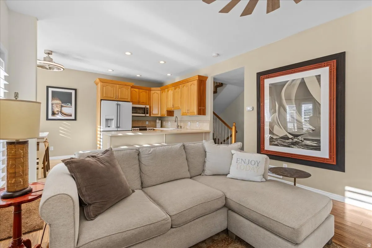 Living room with light wood-style flooring, recessed lighting, and a ceiling fan