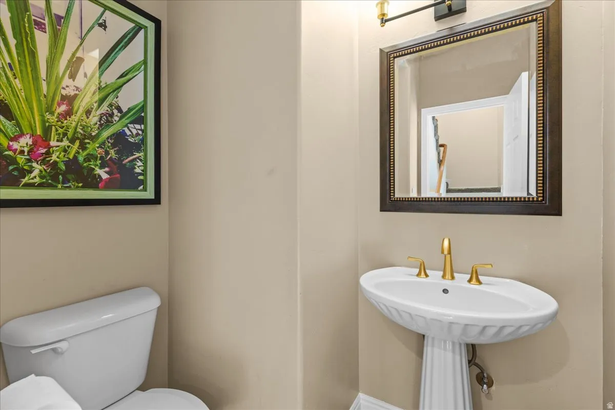 Half bathroom featuring toilet and a sink