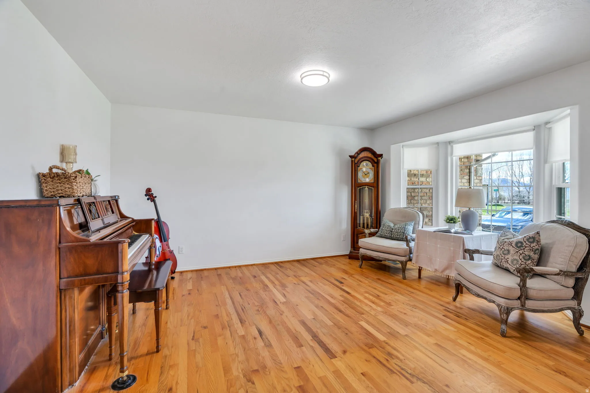 Living area with light wood finished floors and baseboards