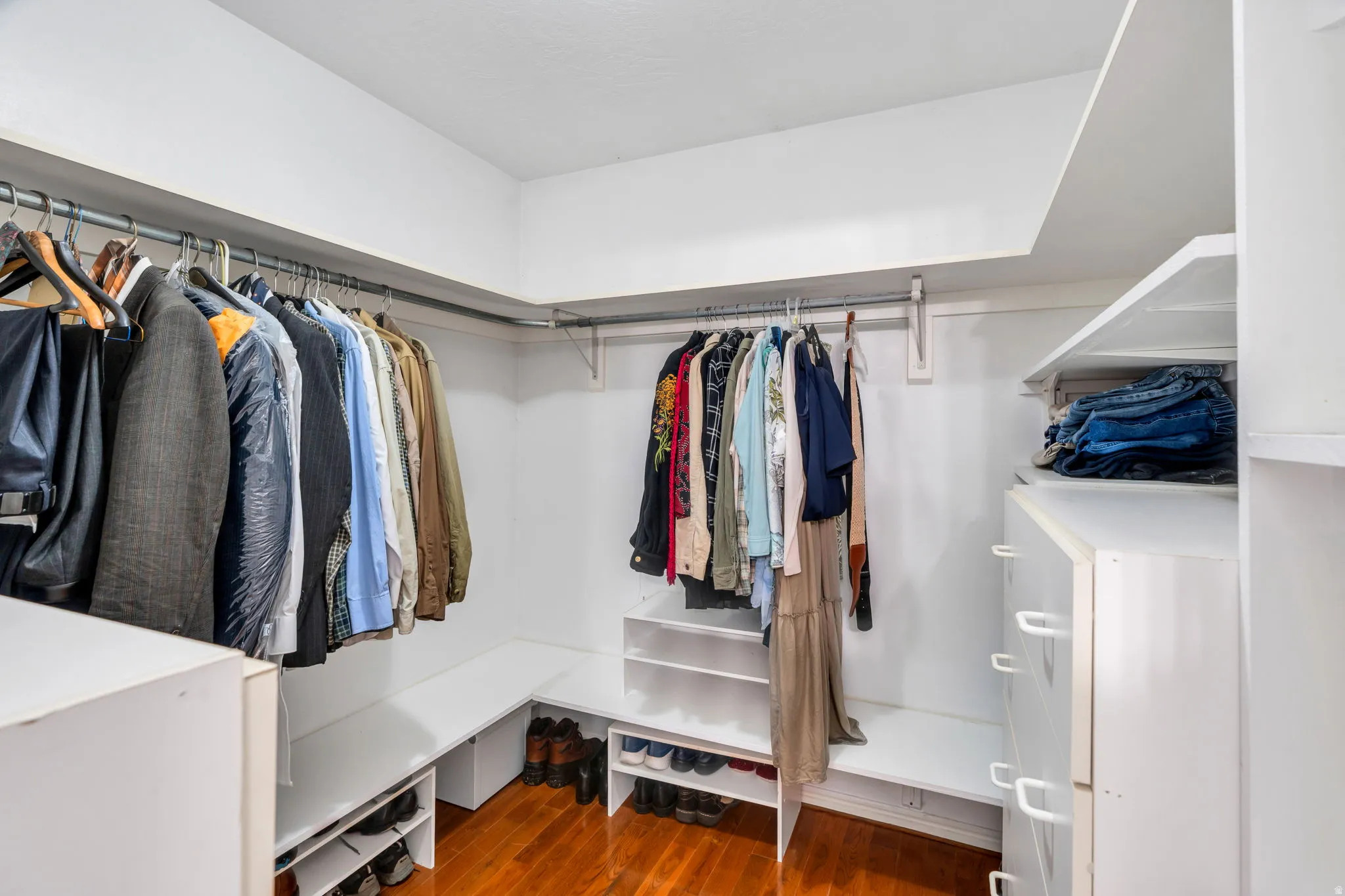Walk in closet featuring dark wood finished floors
