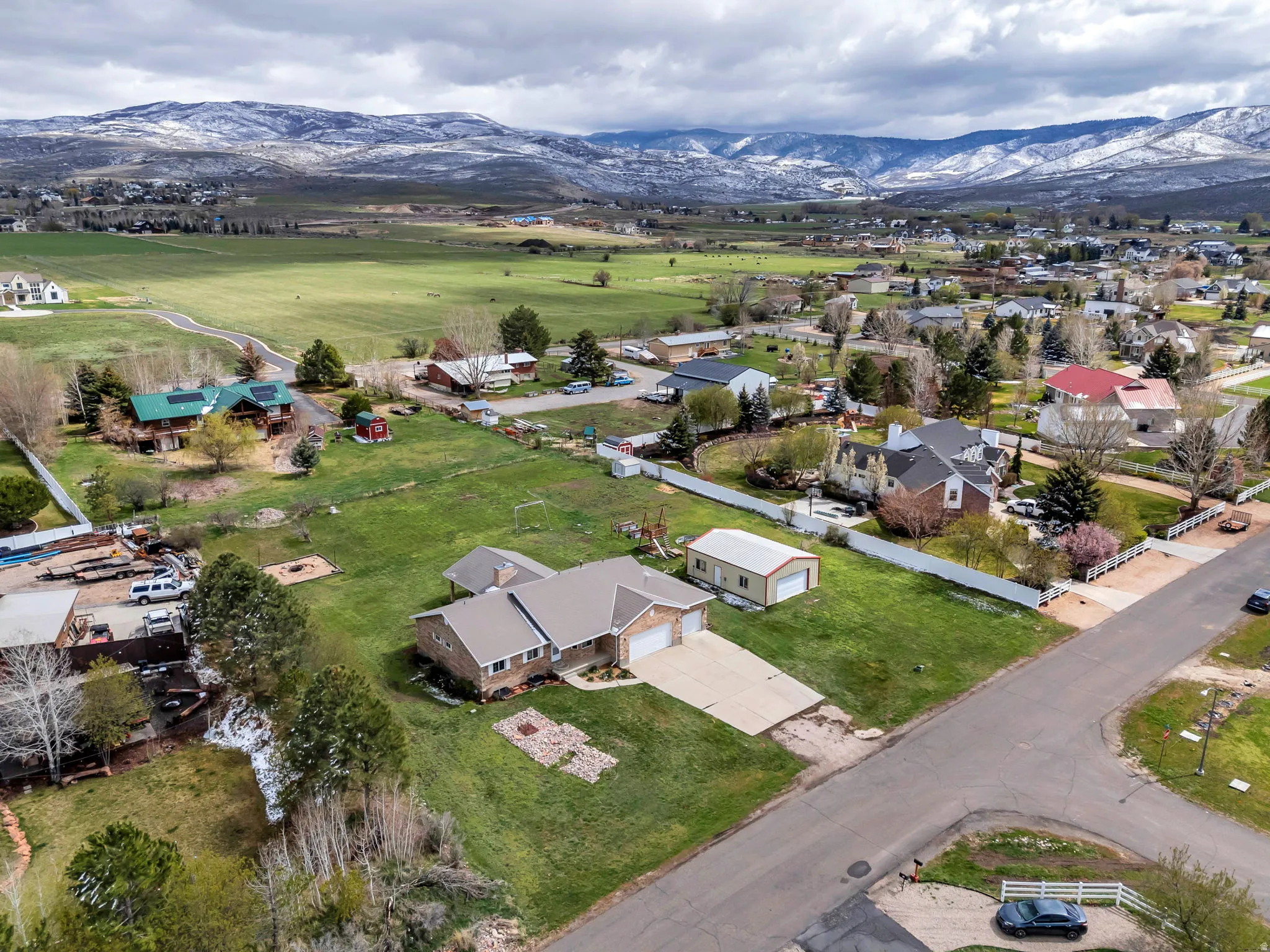 Aerial overview of property's location with a mountainous background and nearby suburban area