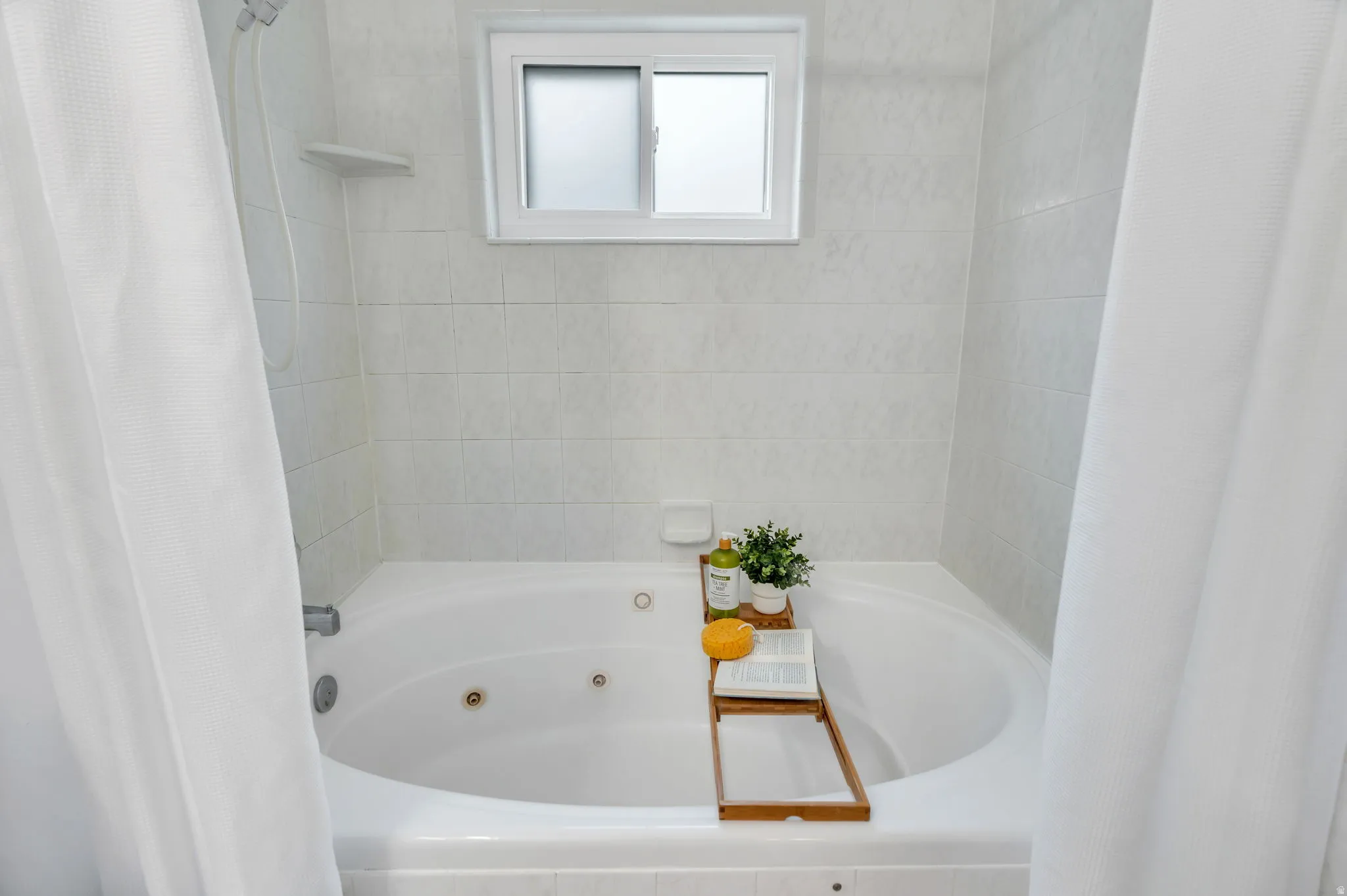 Full bathroom with a combined bath / shower with jetted tub