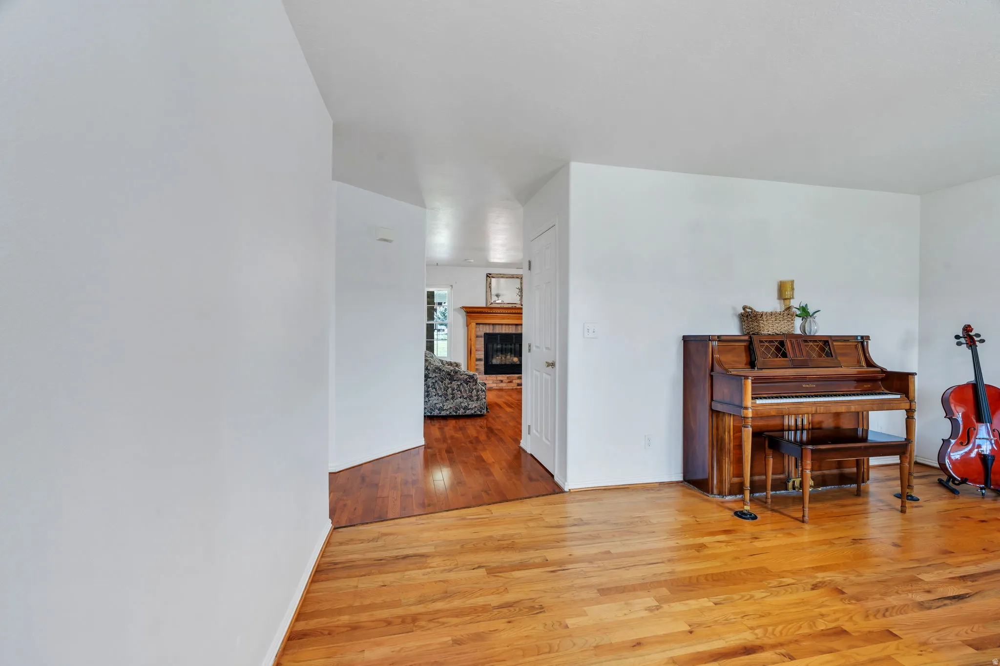 Living area with light wood-type flooring and a fireplace