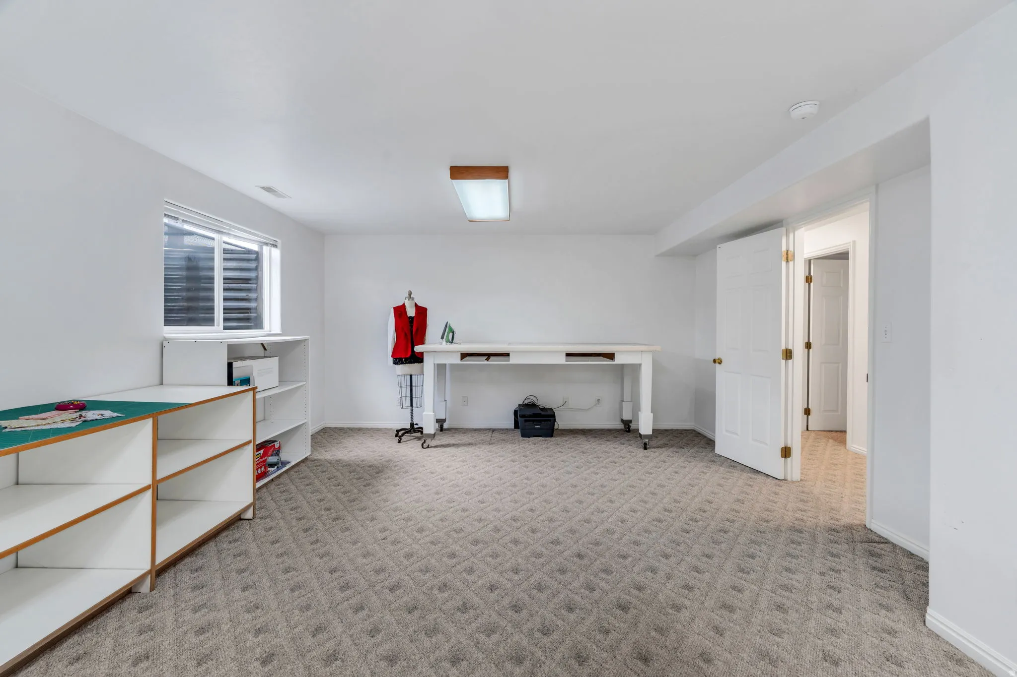 Below grade area with baseboards and light colored carpet