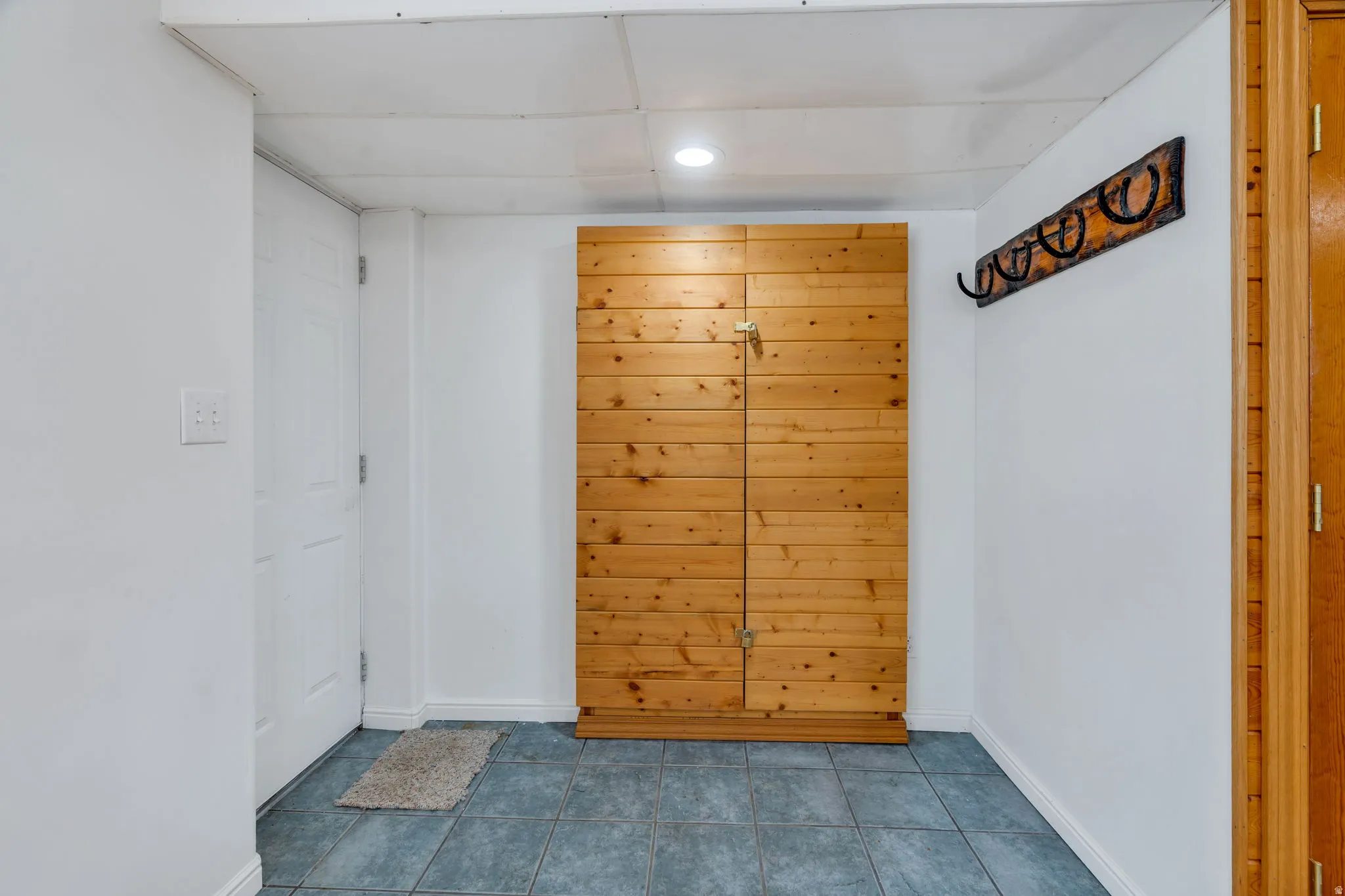 Doorway featuring tile patterned flooring and recessed lighting