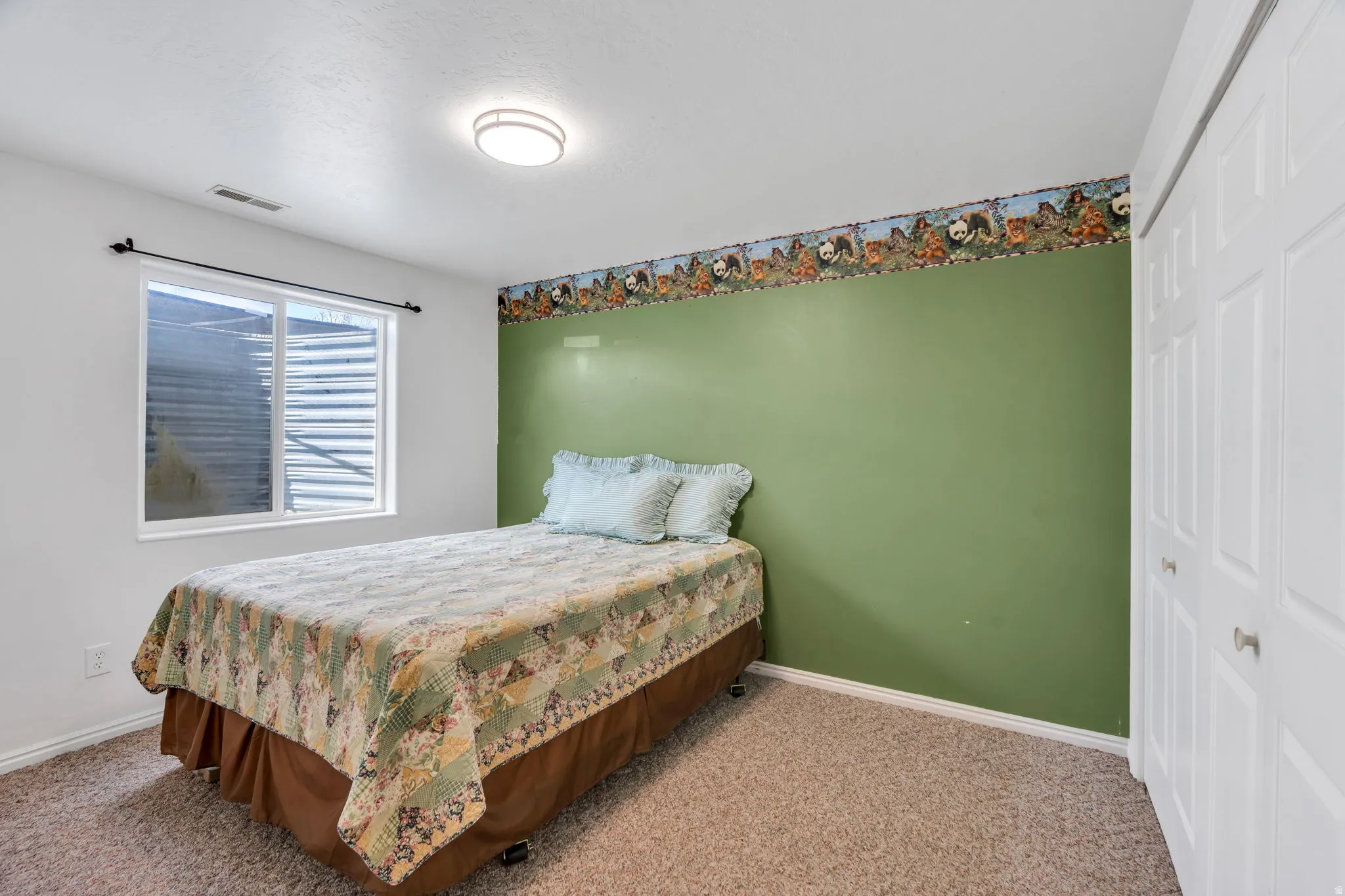 Bedroom featuring a closet and light colored carpet