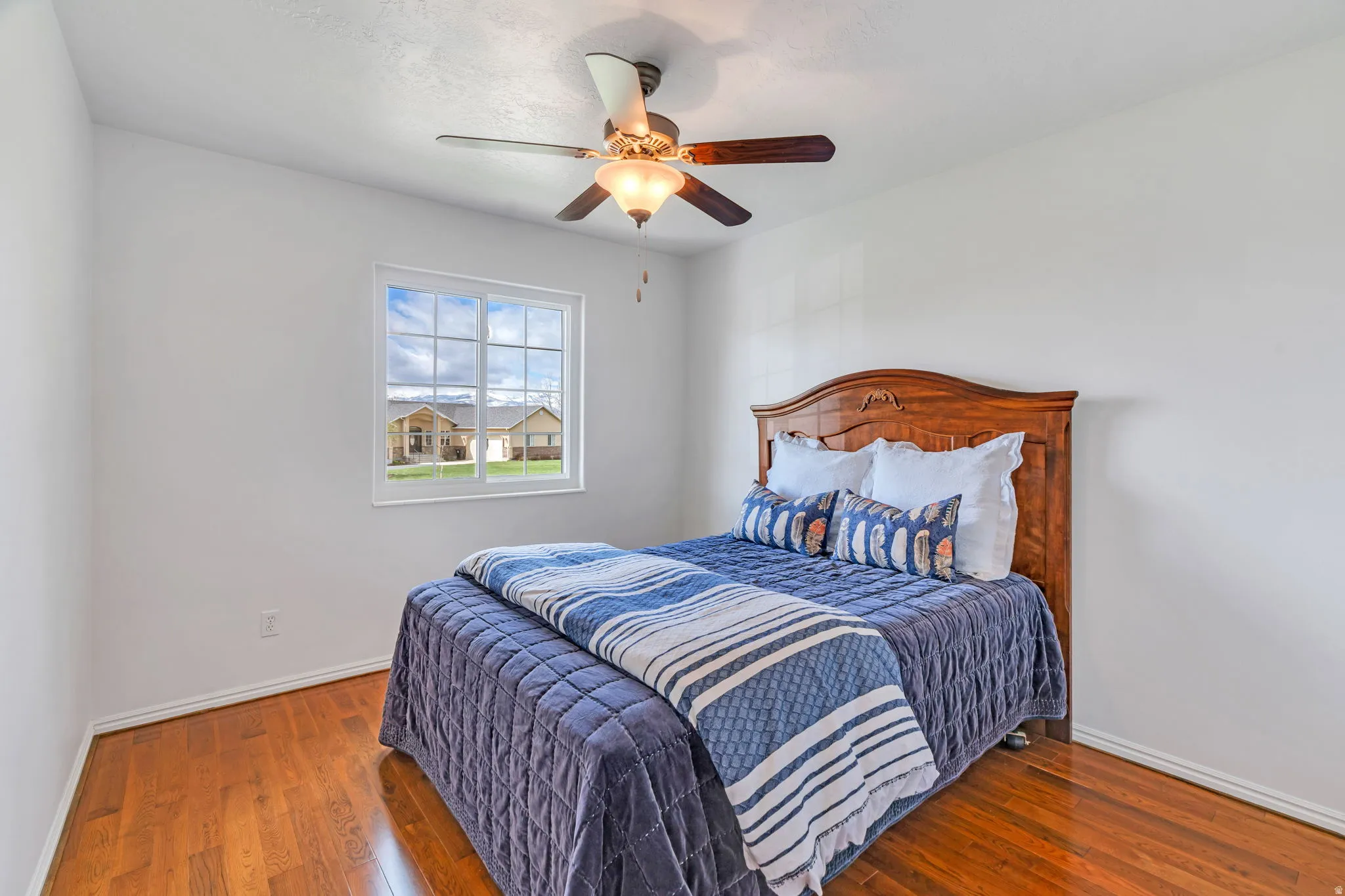 Bedroom featuring wood-type flooring and a ceiling fan