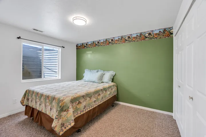 Bedroom featuring a closet and light colored carpet