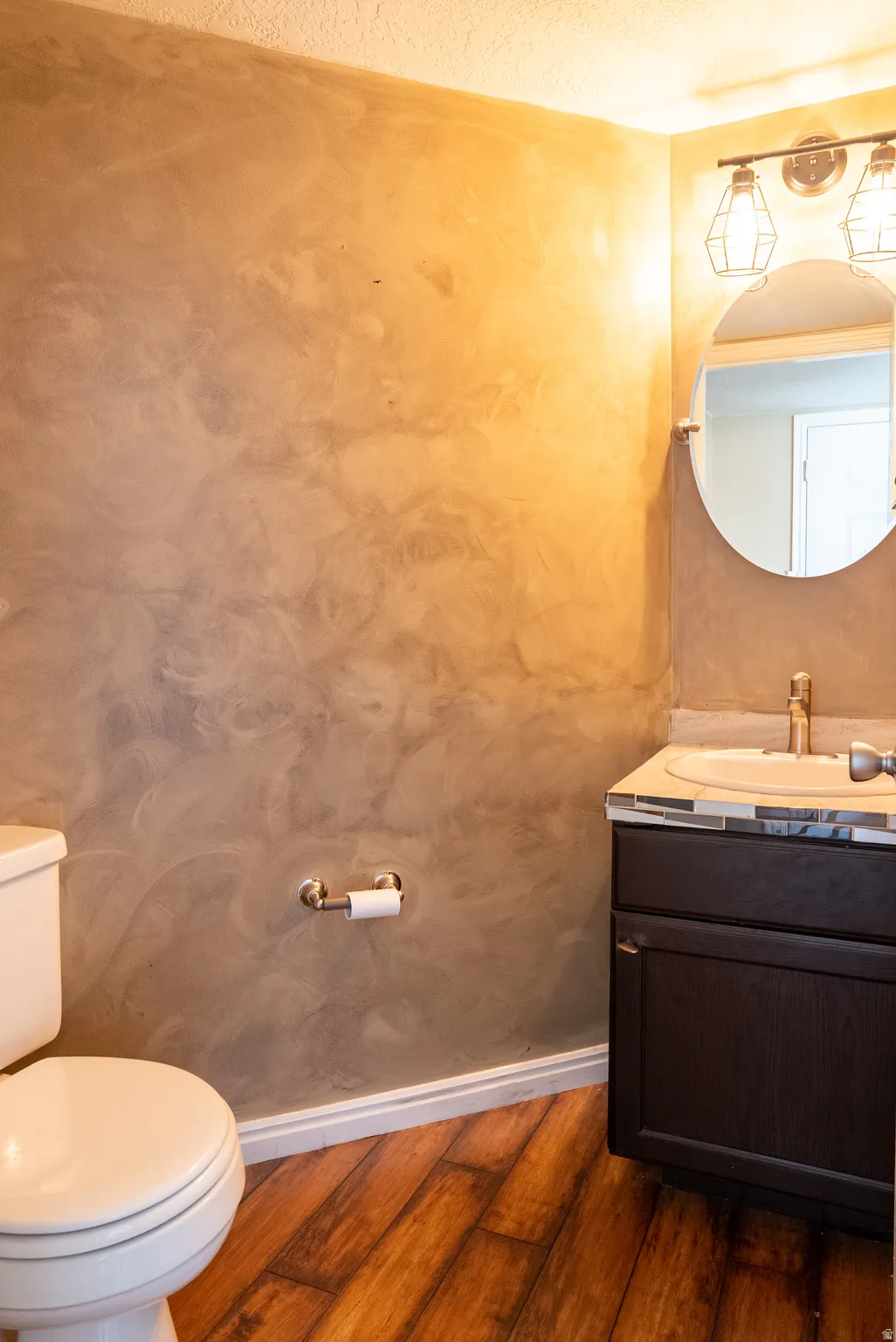 Bathroom featuring vanity and dark wood-style flooring