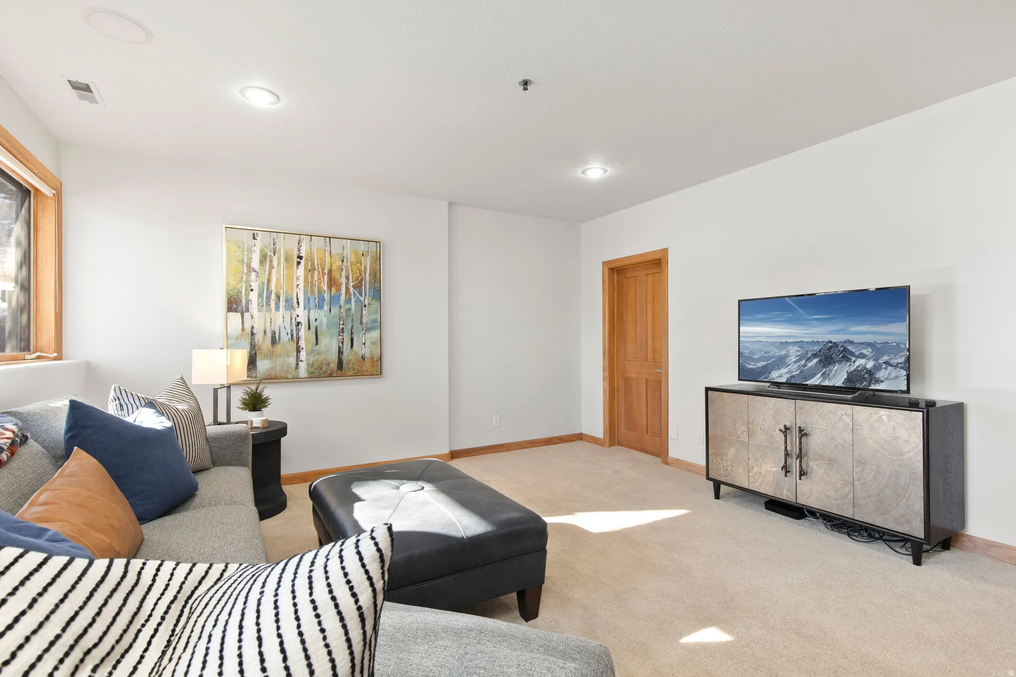Living room featuring light colored carpet and recessed lighting