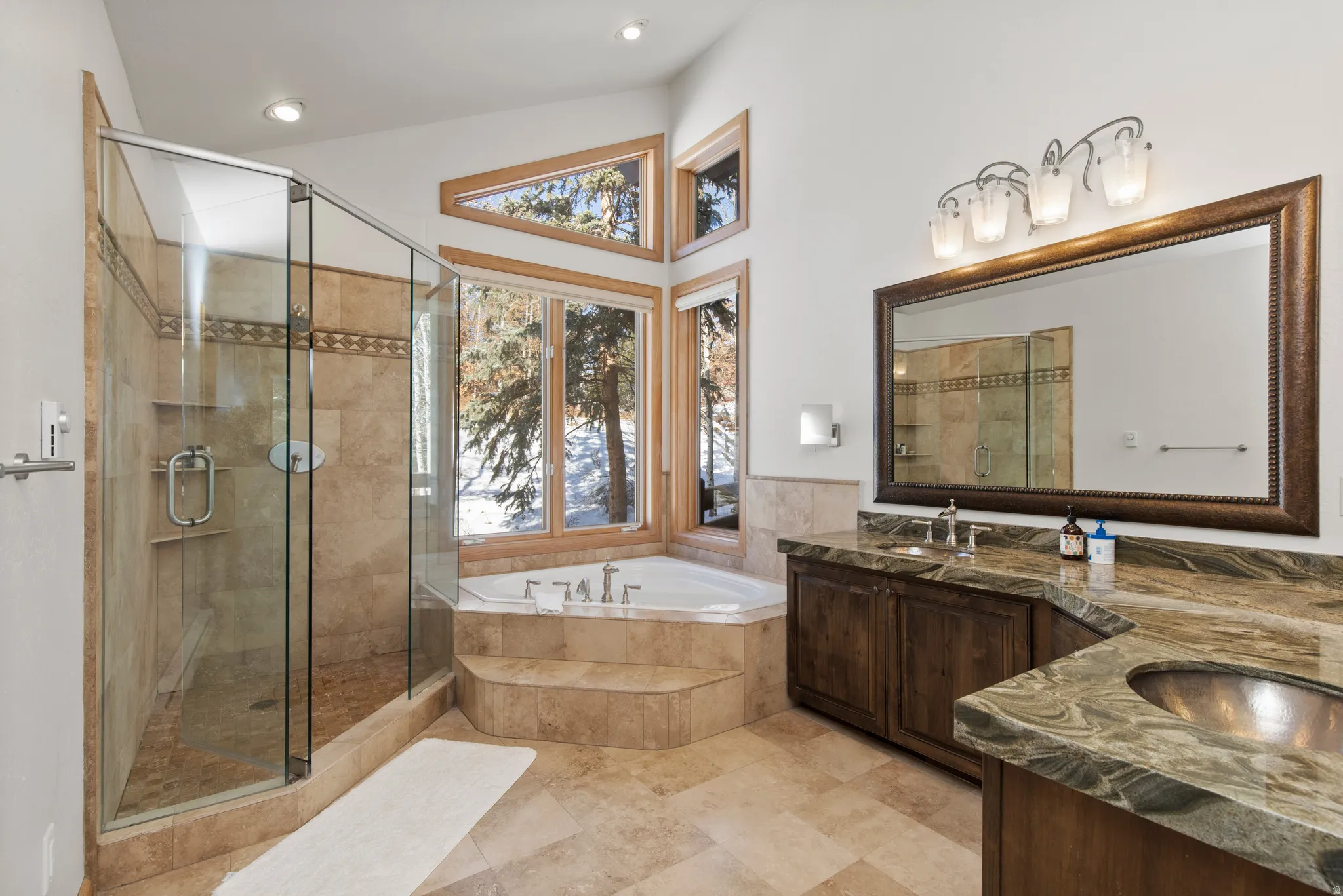 Full bath featuring double vanity, a stall shower, and a bath