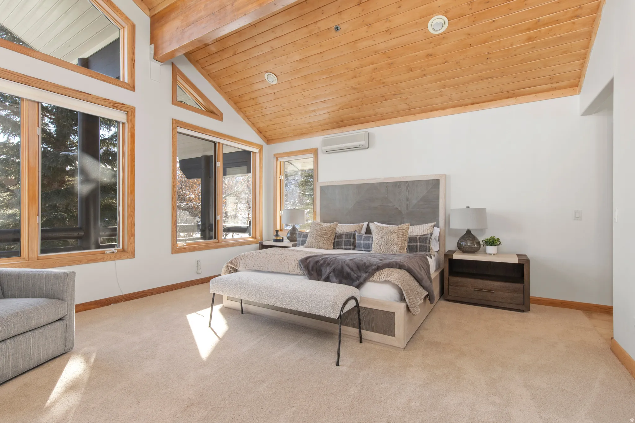 Bedroom with a high wood beamed ceiling, light carpet, and recessed lighting