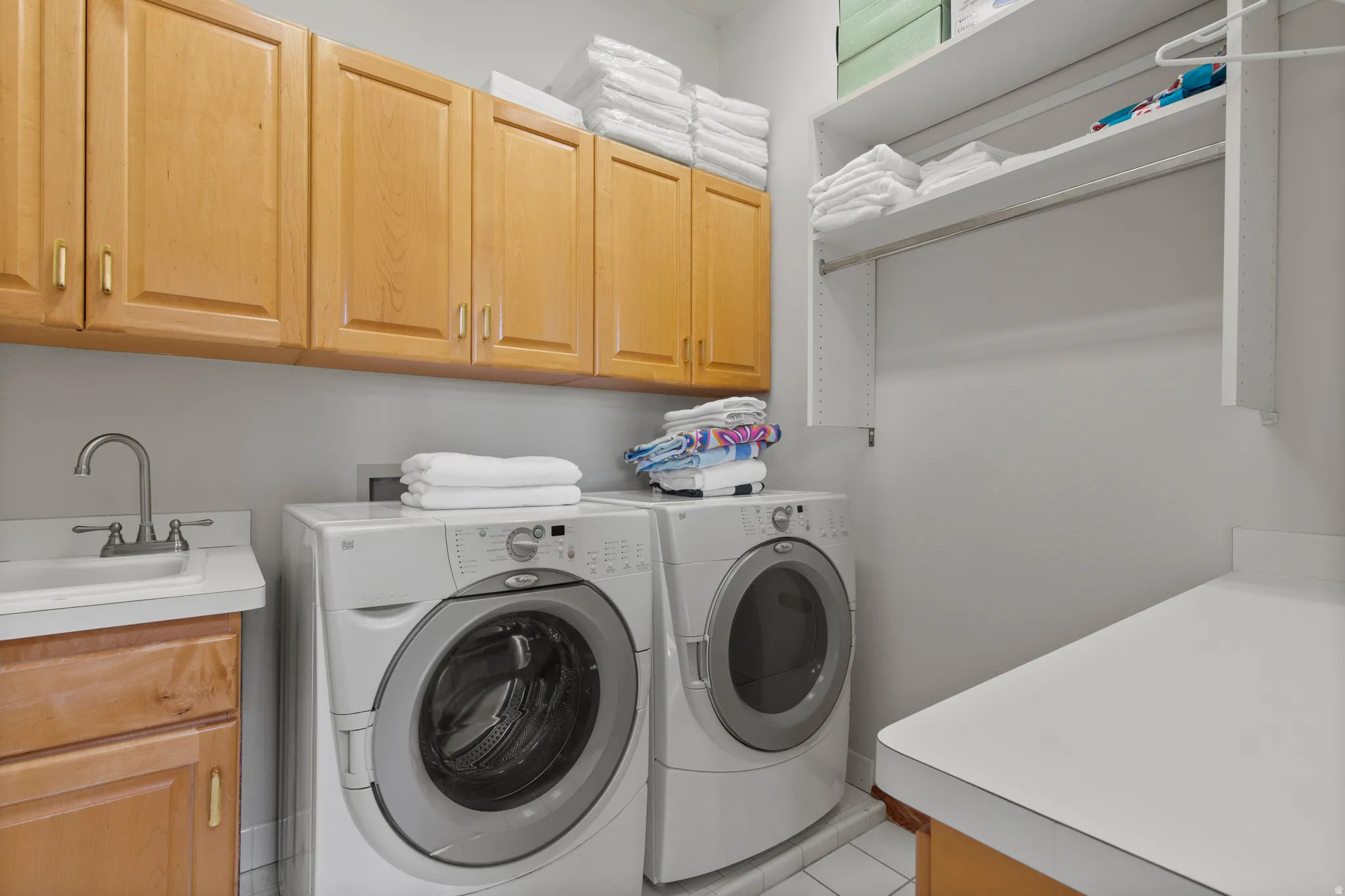 Laundry area with cabinet space and washing machine and clothes dryer