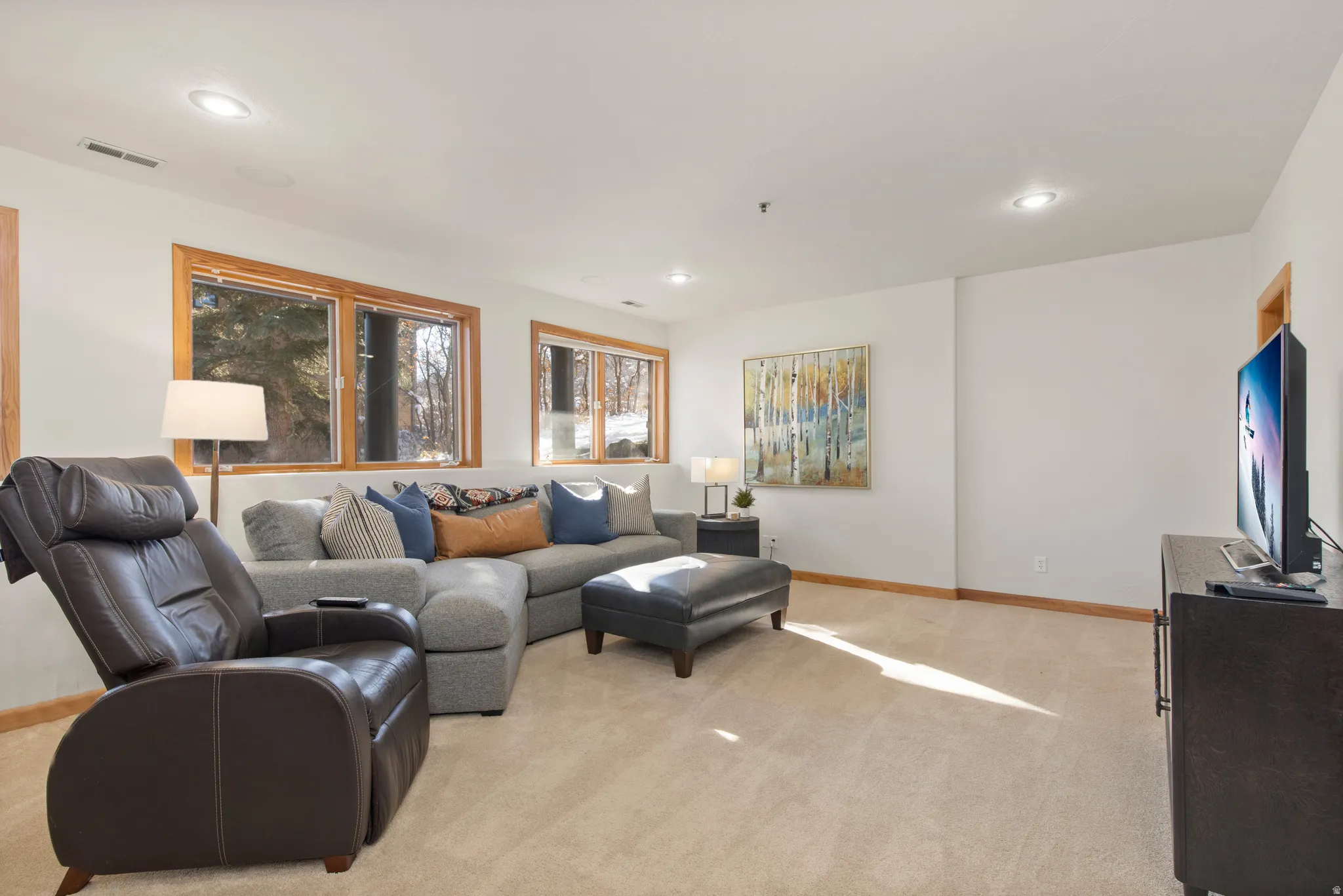 Living room featuring light colored carpet and recessed lighting