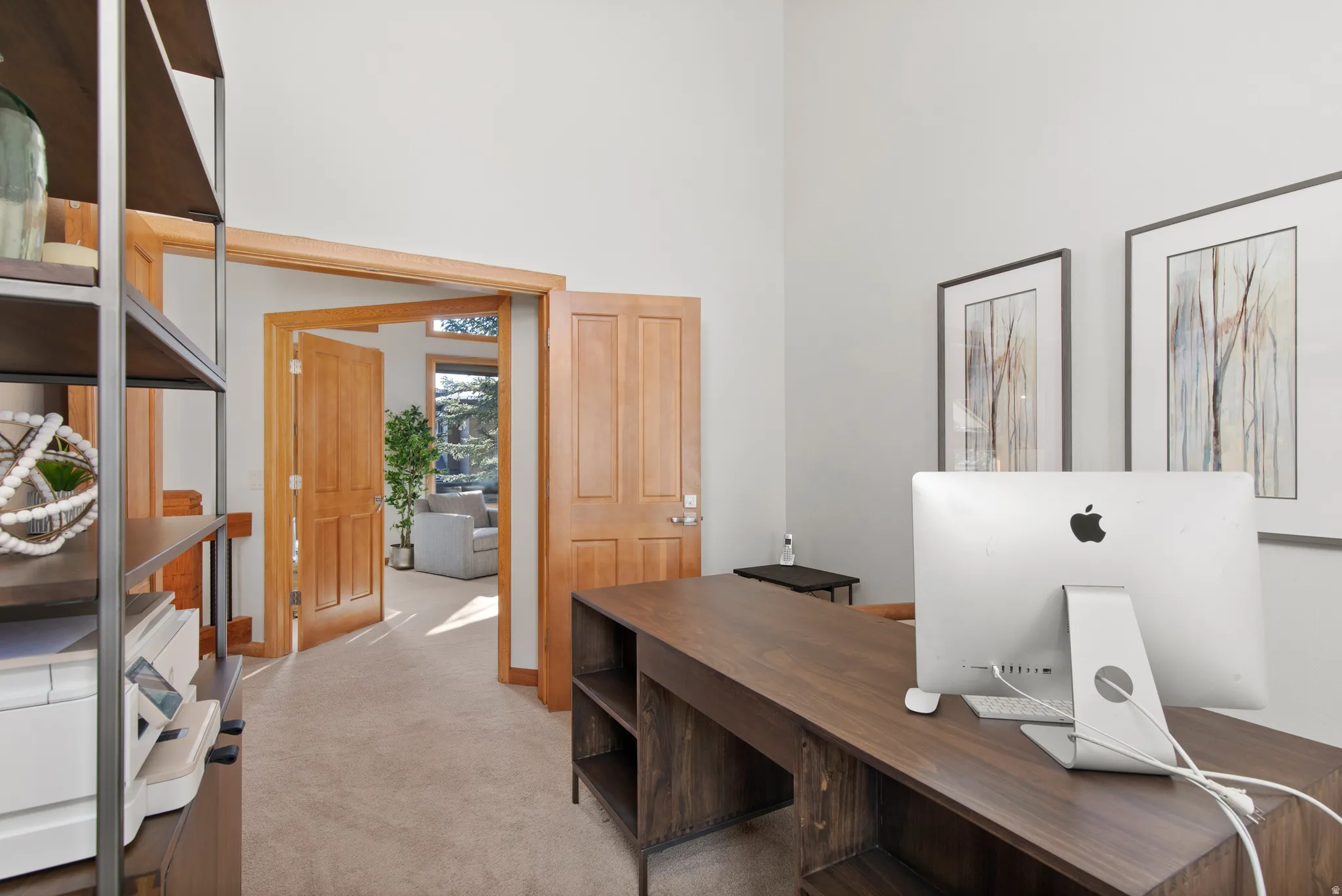 Office with light carpet and a high ceiling