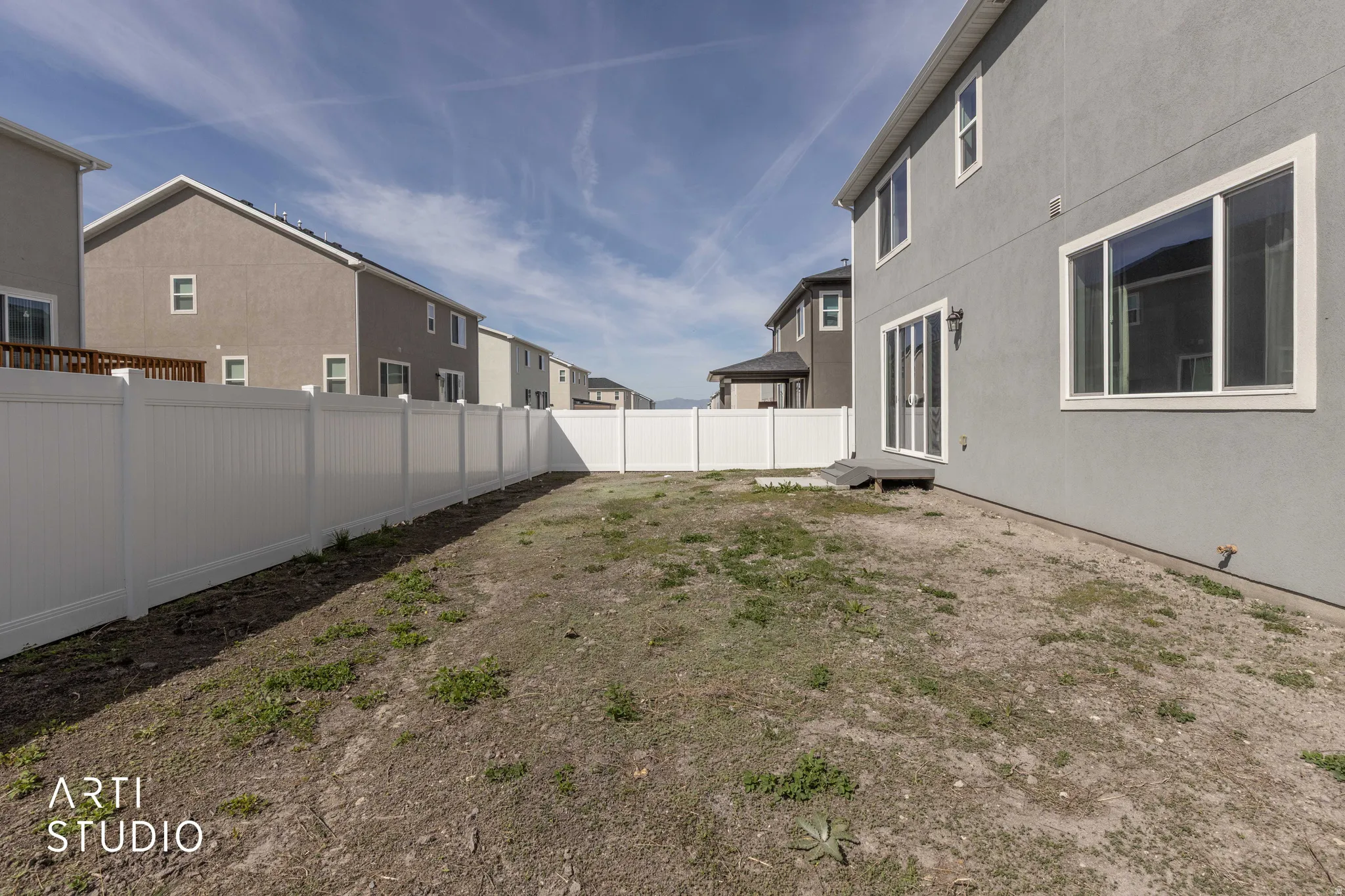 Fenced backyard with a residential view