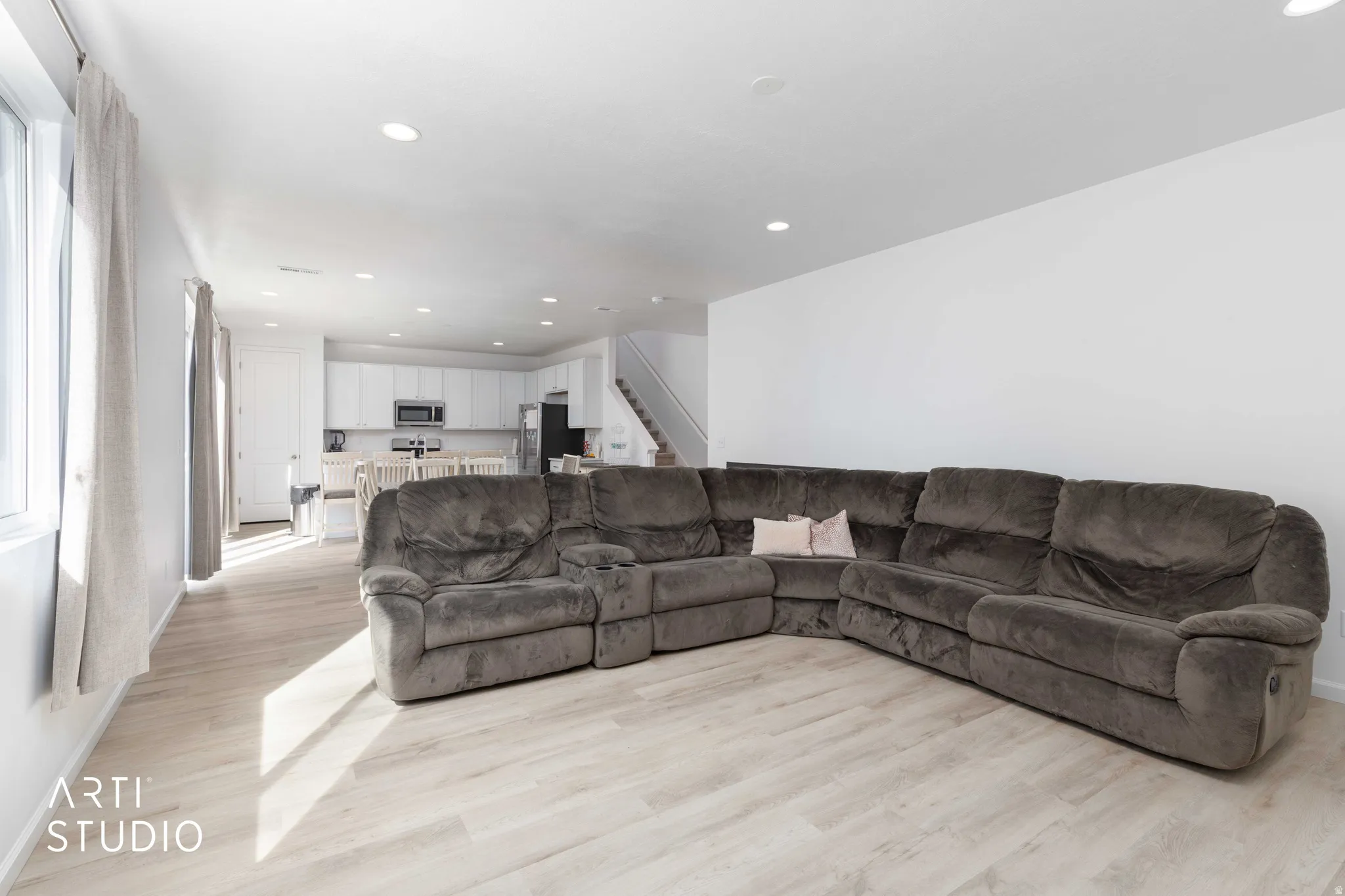 Living area with recessed lighting and light wood-style floors