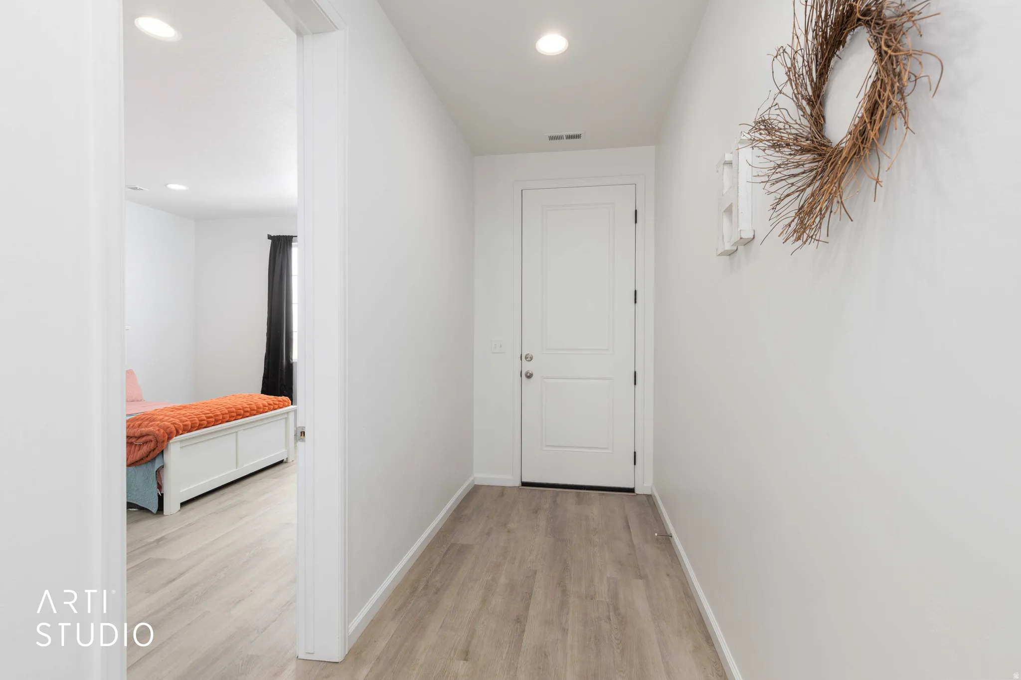 Corridor with light wood finished floors and recessed lighting