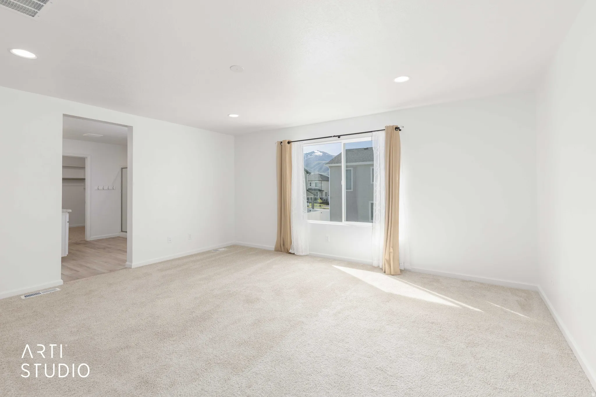 Spare room featuring light colored carpet and recessed lighting