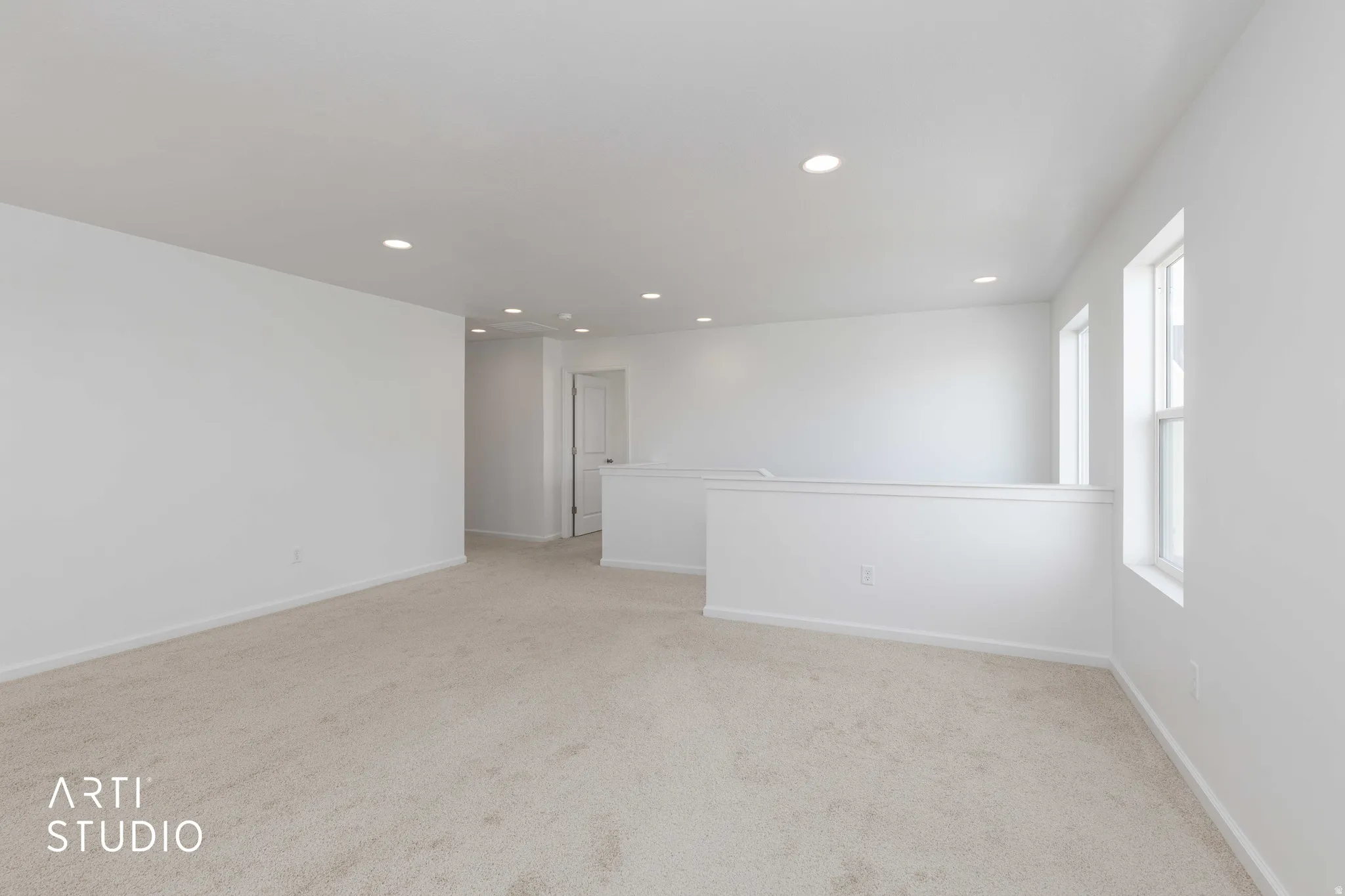 Empty room featuring recessed lighting and light colored carpet