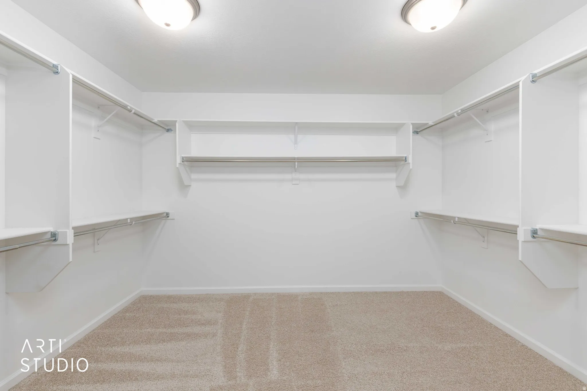 Walk in closet with light carpet