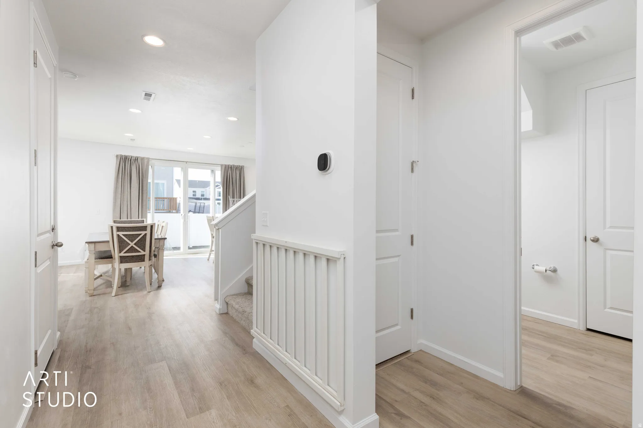 Hallway featuring light wood-style floors and recessed lighting