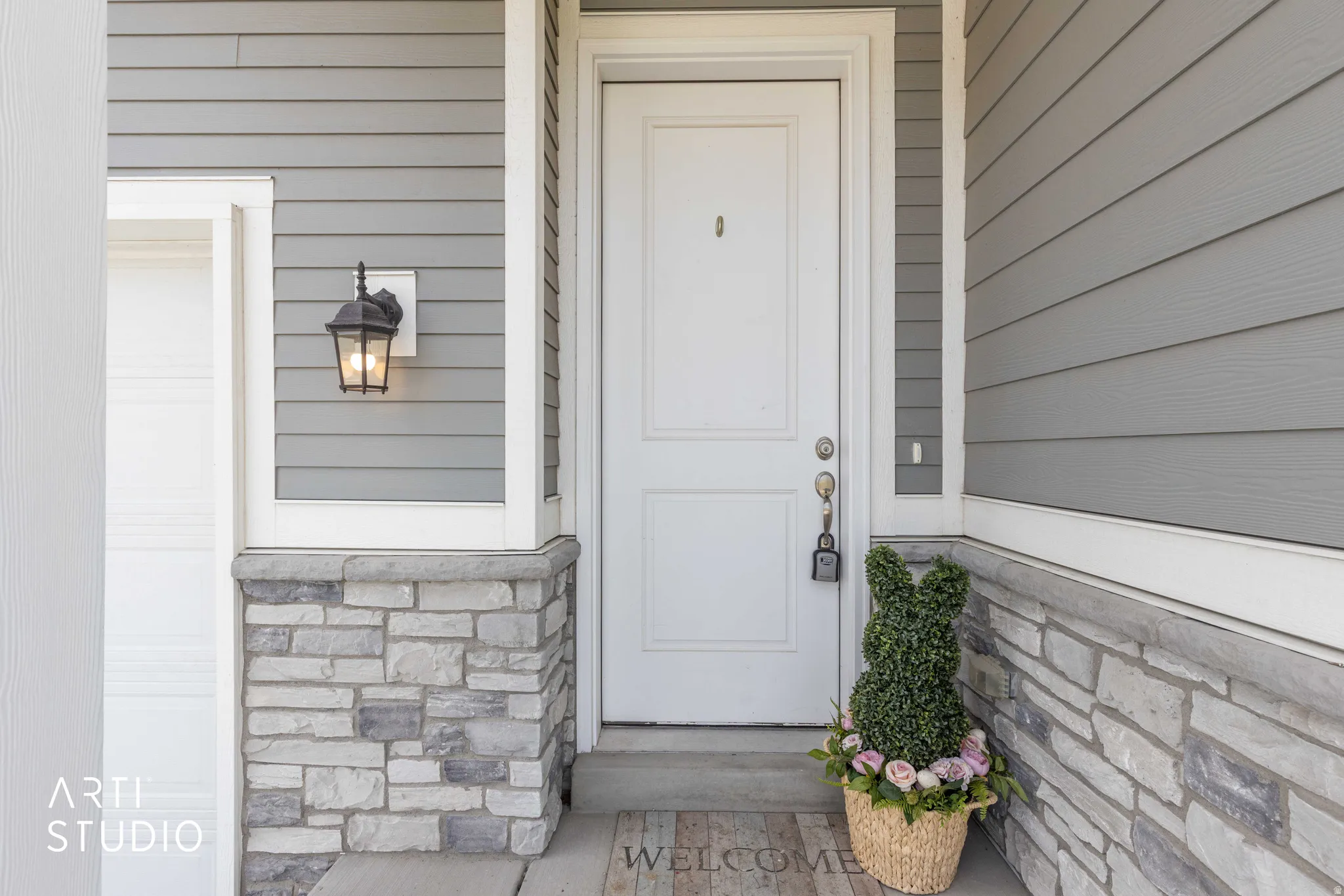 View of exterior entry with stone siding