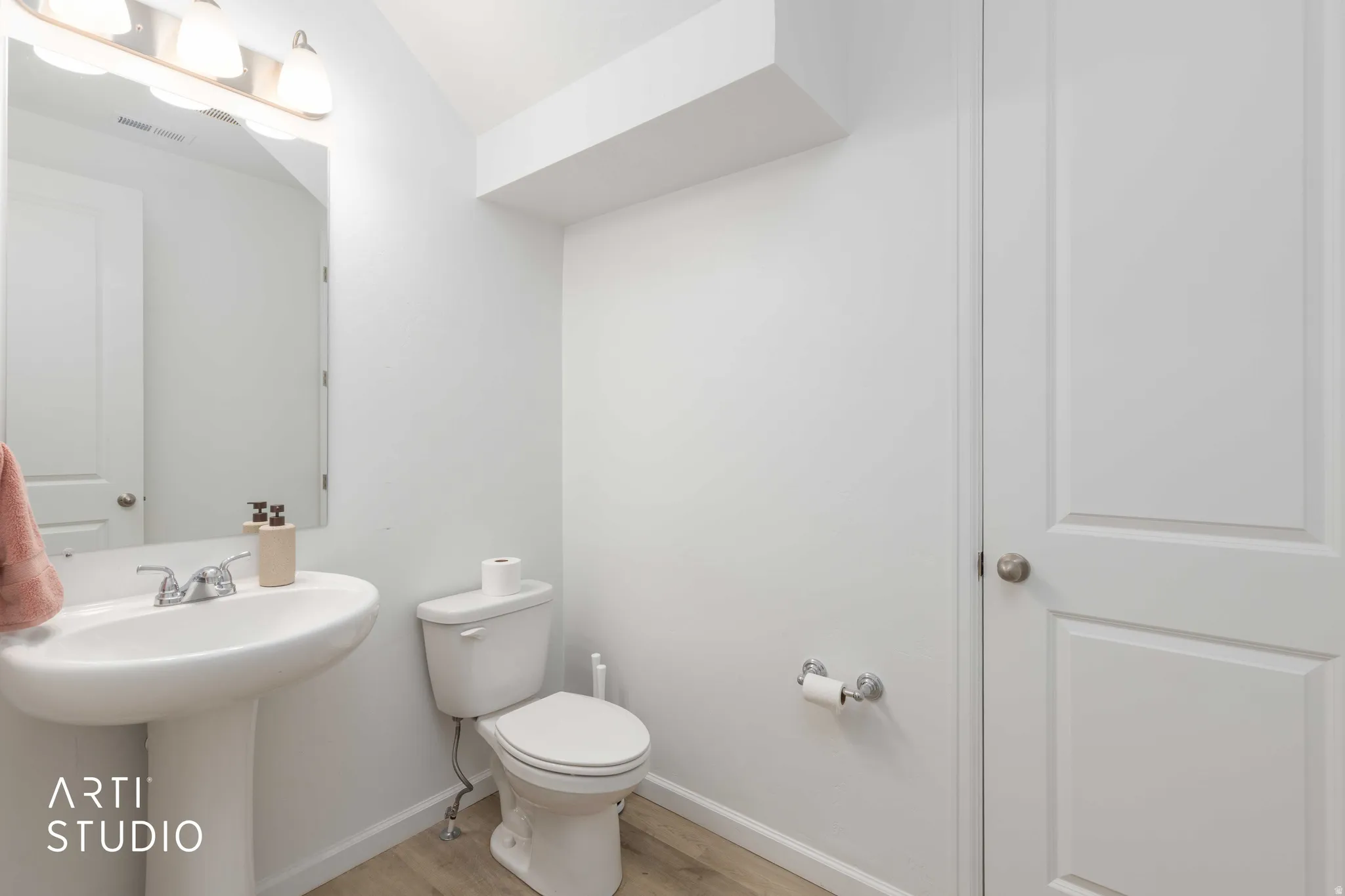 Bathroom featuring toilet and light wood-style floors