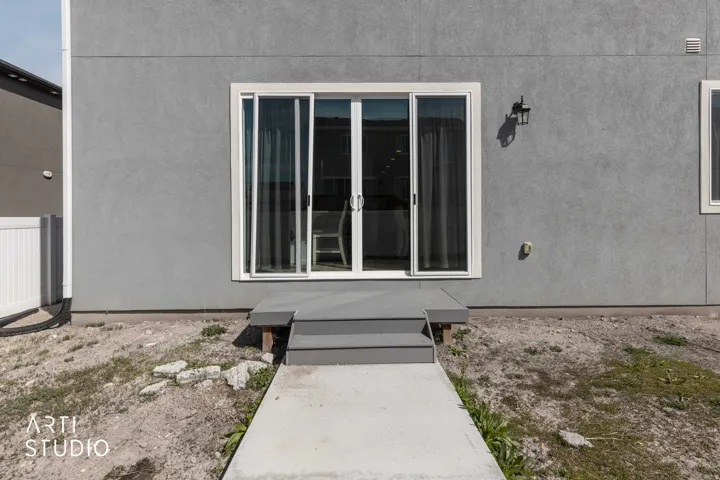Entrance to property featuring stucco siding